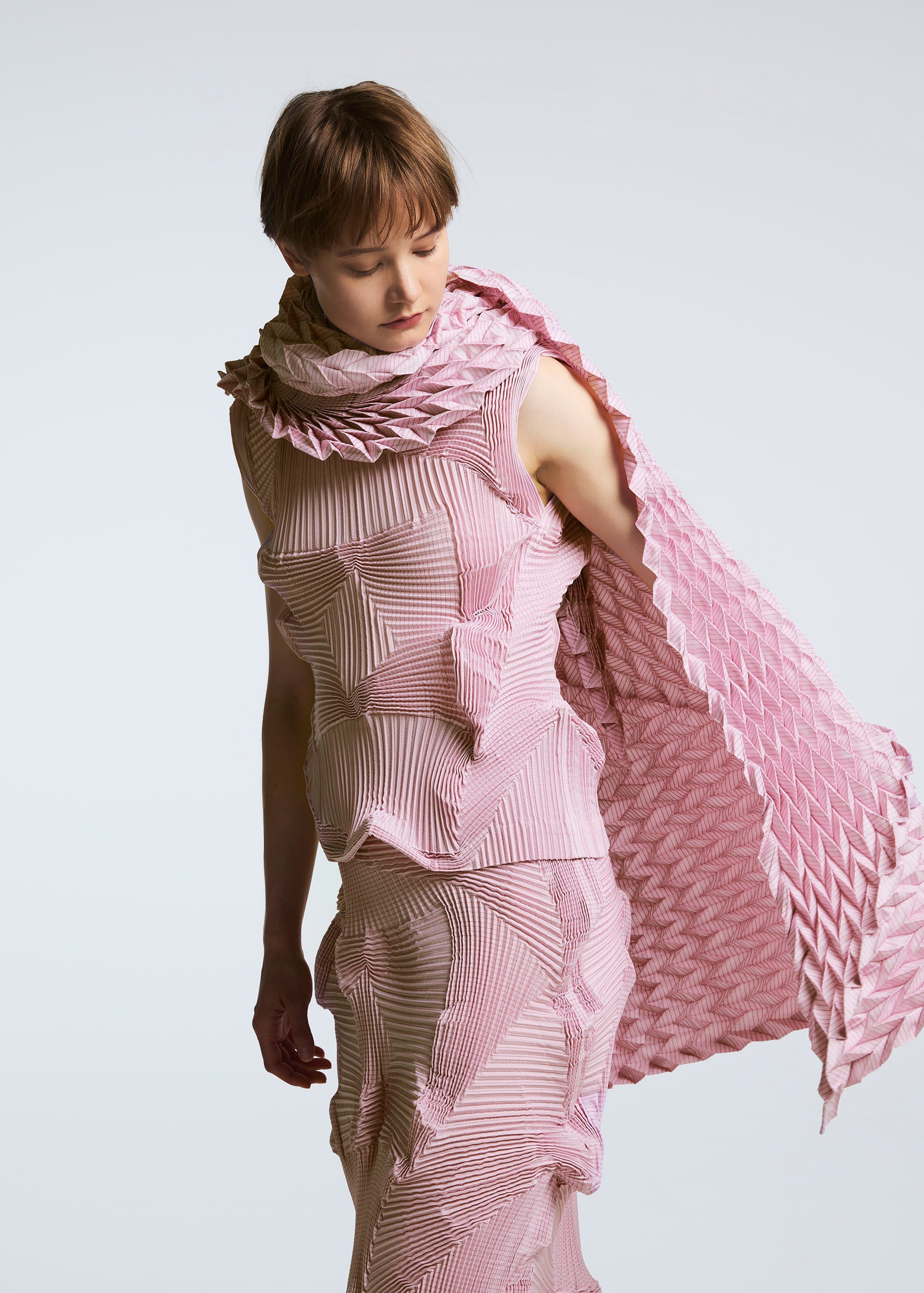 A model wears the A-POC ABLE ISSEY MIYAKE TYPE O STOLE stole.