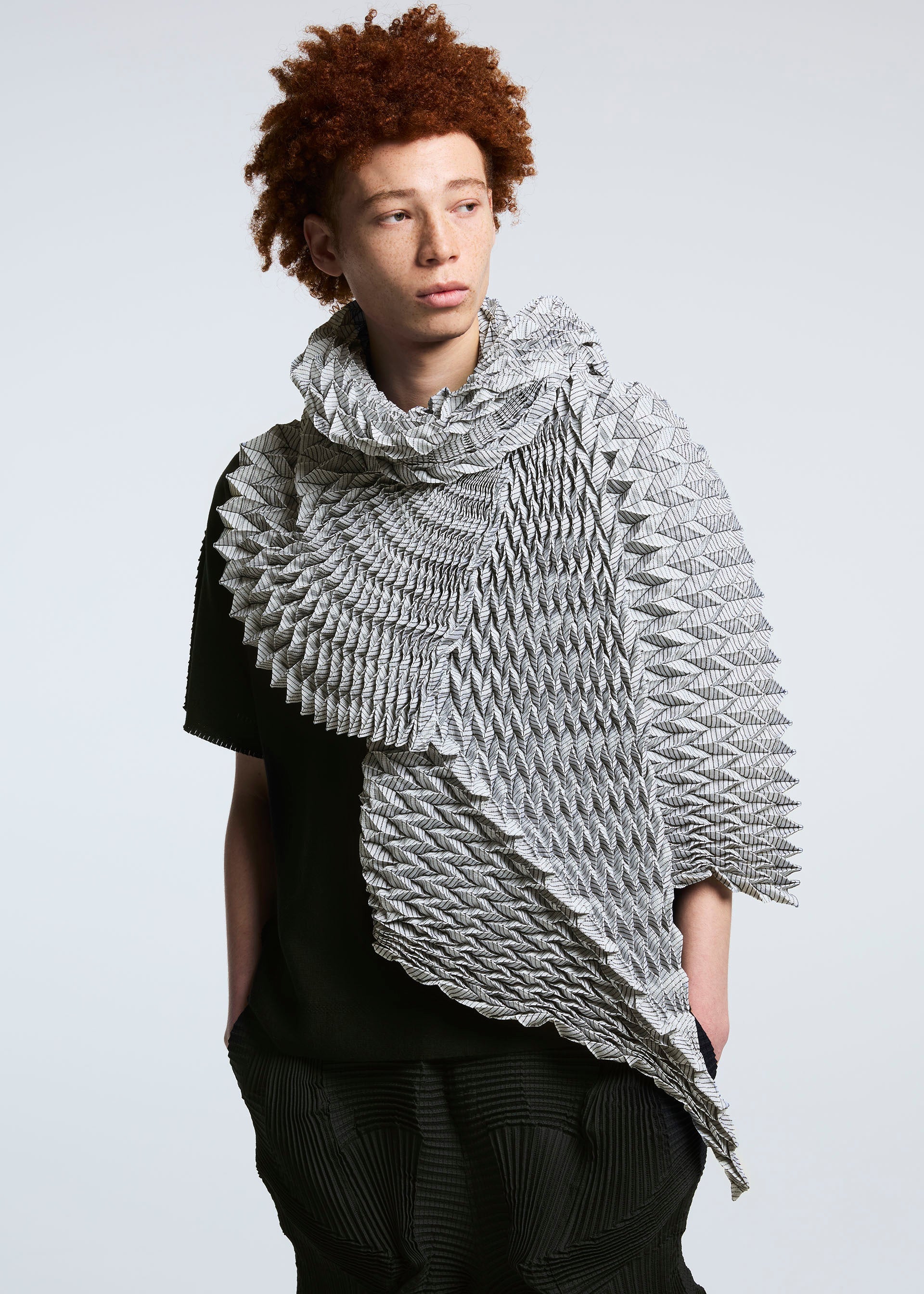A model wears the A-POC ABLE ISSEY MIYAKE TYPE O STOLE stole.