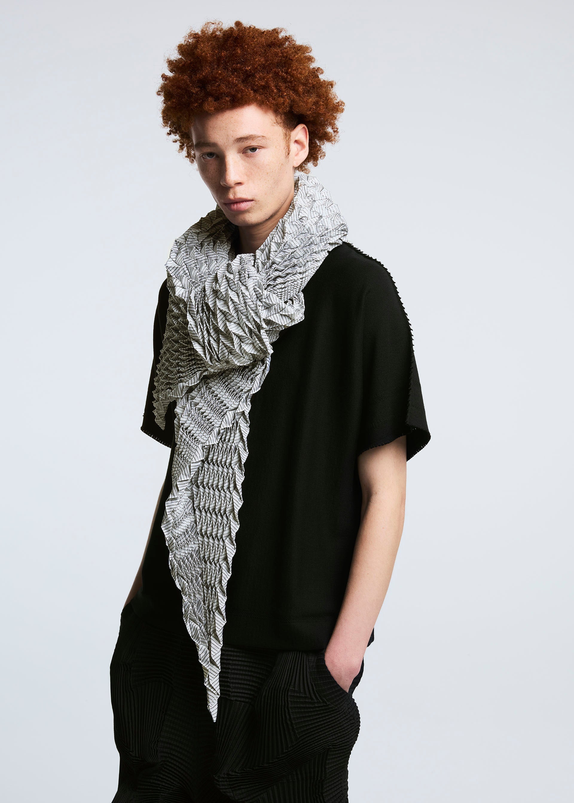 A model wears the A-POC ABLE ISSEY MIYAKE TYPE O STOLE stole.