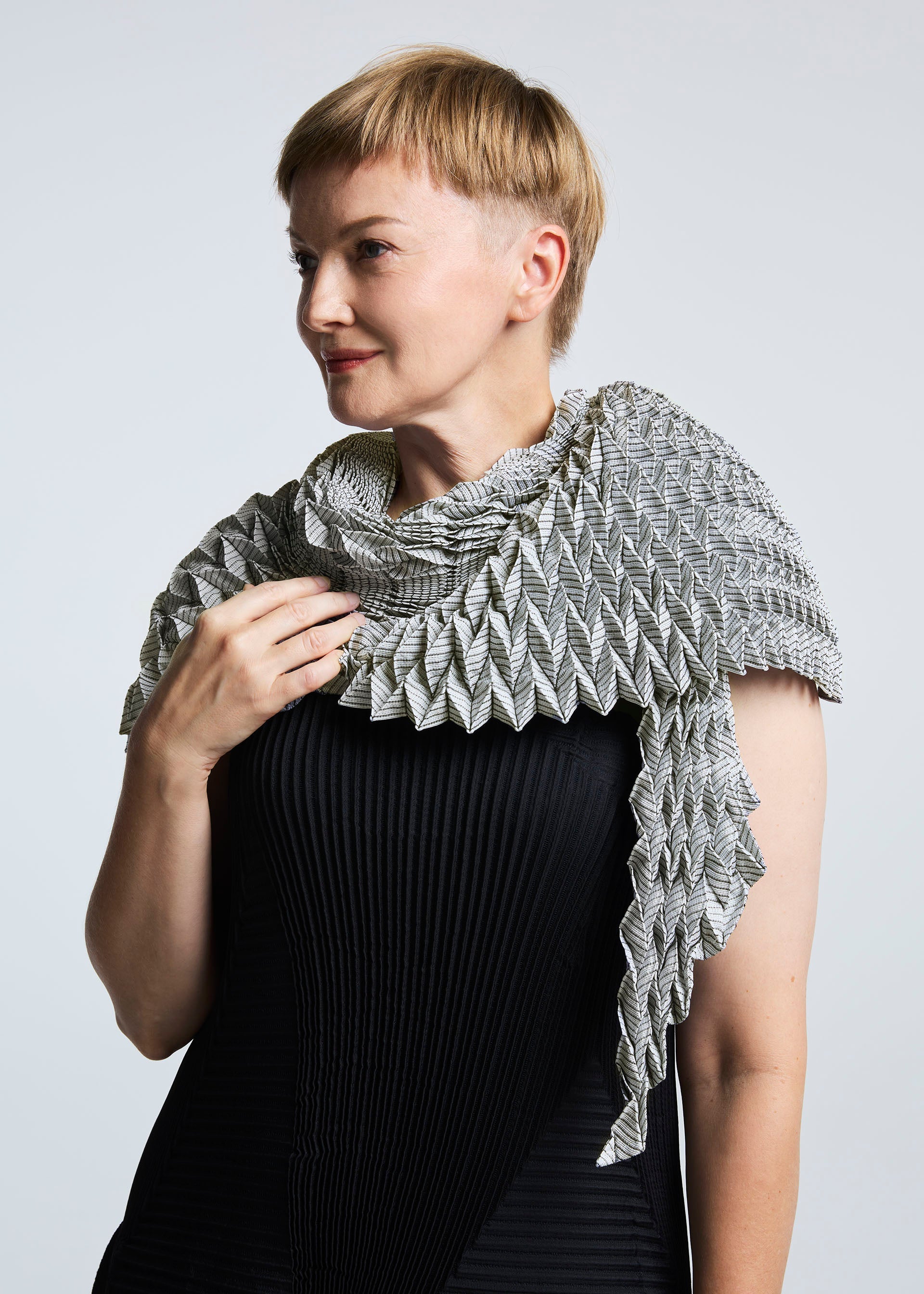 A model wears the A-POC ABLE ISSEY MIYAKE TYPE O STOLE stole.
