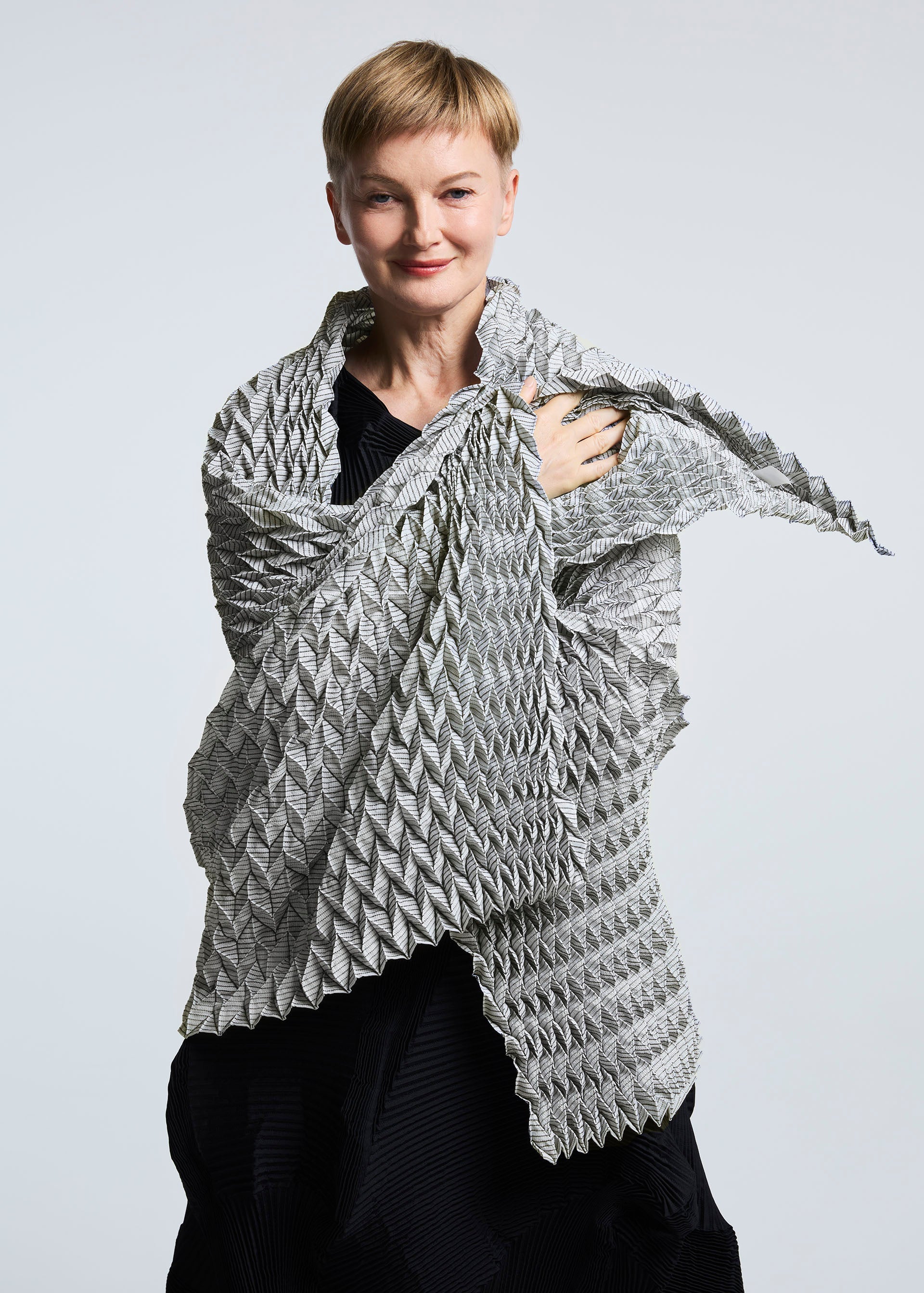 A model wears the A-POC ABLE ISSEY MIYAKE TYPE O STOLE stole.