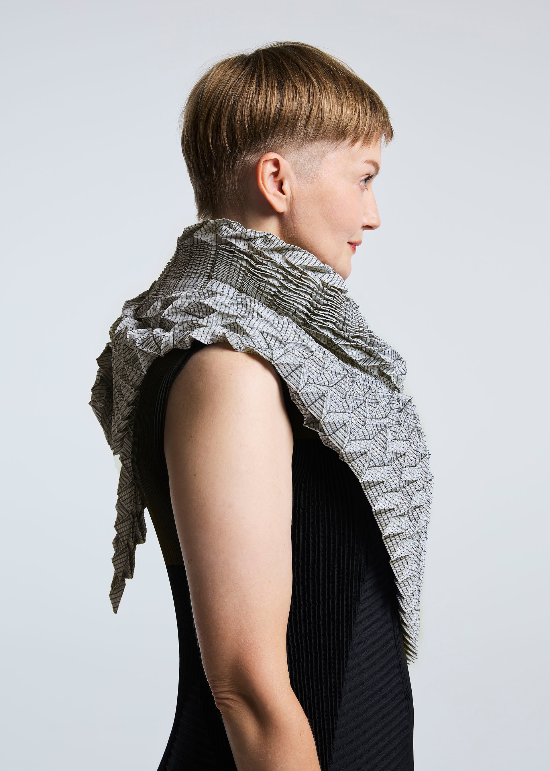 A model wears the A-POC ABLE ISSEY MIYAKE TYPE O STOLE stole.