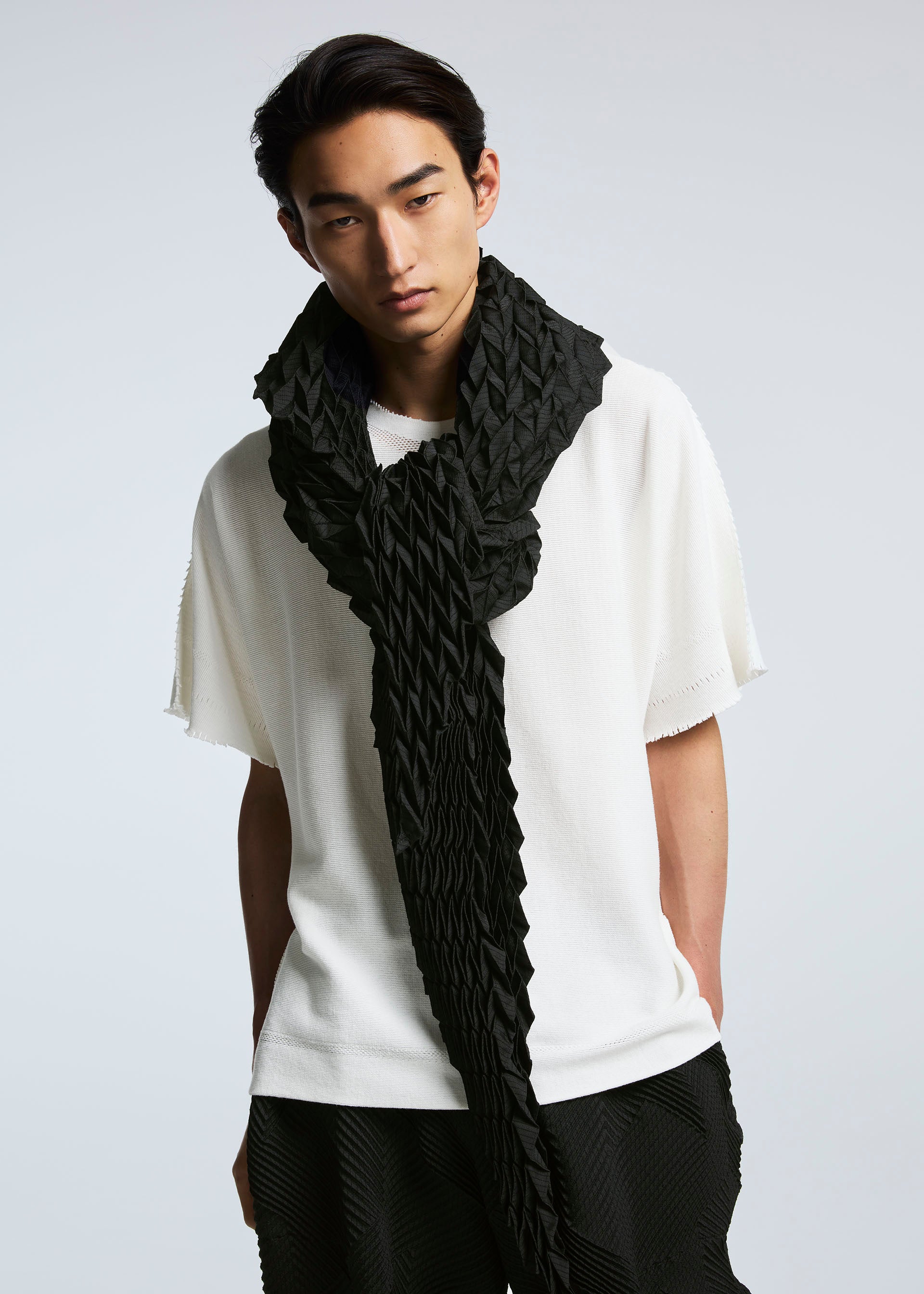 A model wears the A-POC ABLE ISSEY MIYAKE TYPE O STOLE stole.