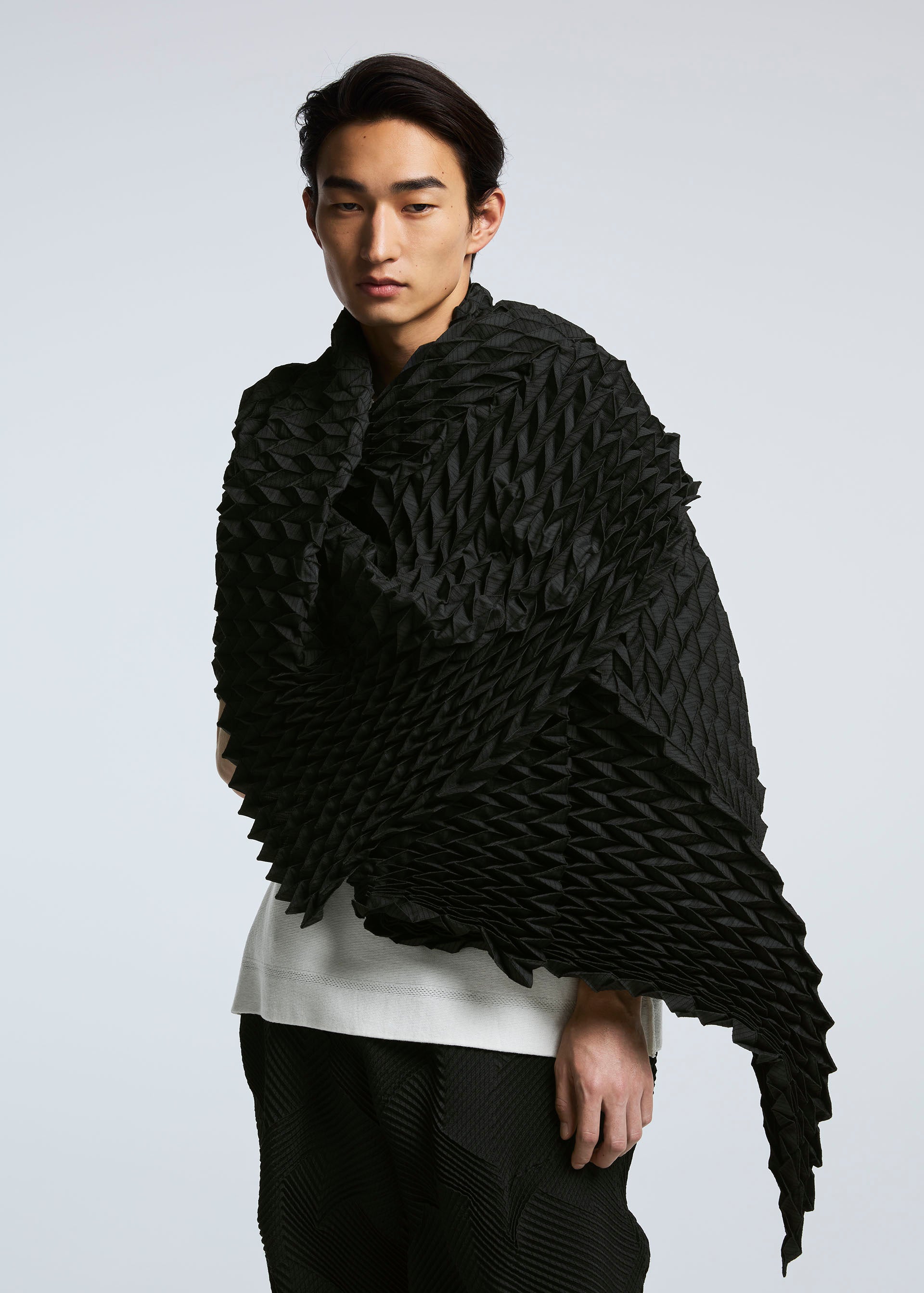A model wears the A-POC ABLE ISSEY MIYAKE TYPE O STOLE stole.