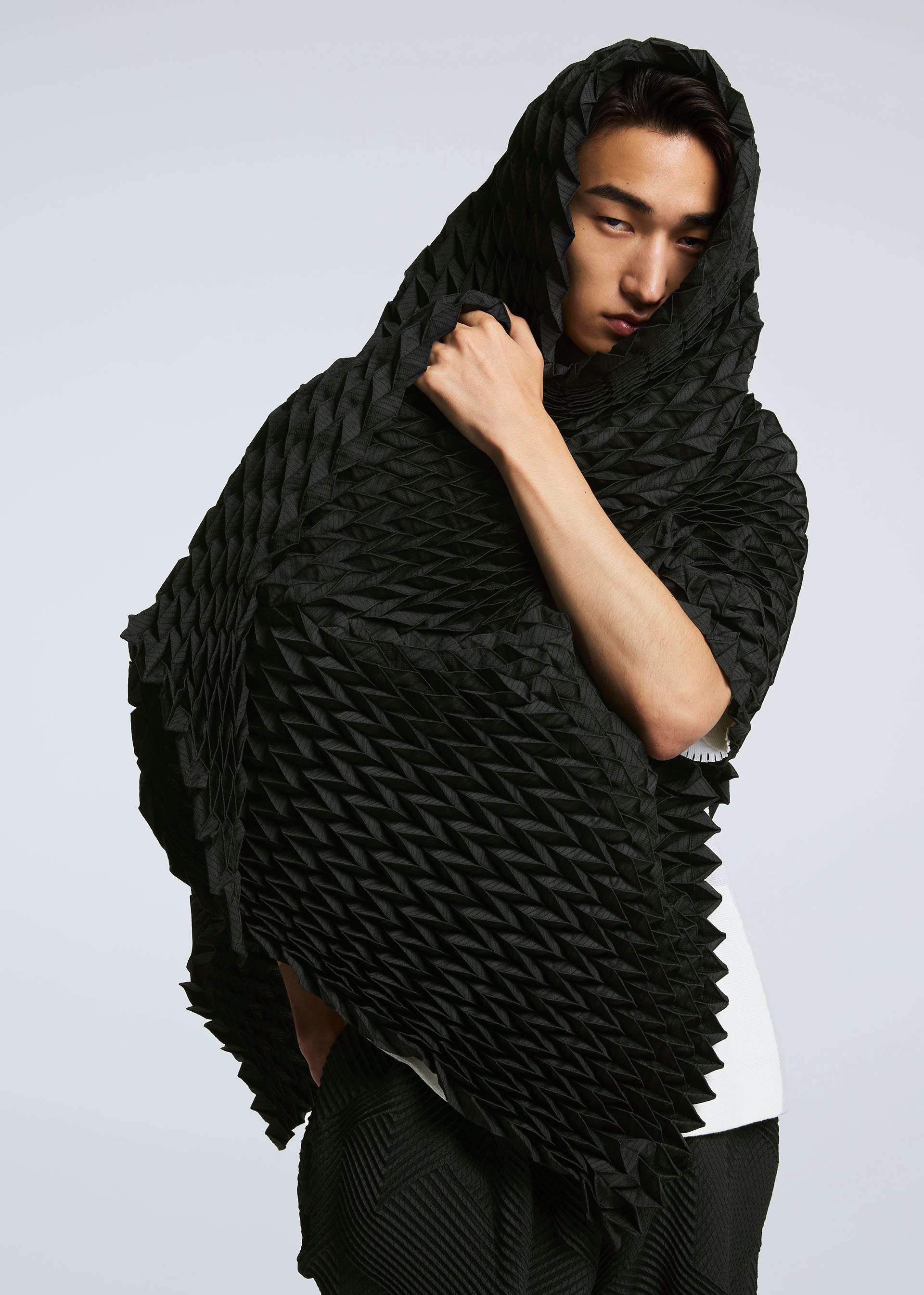 A model wears the A-POC ABLE ISSEY MIYAKE TYPE O STOLE stole.