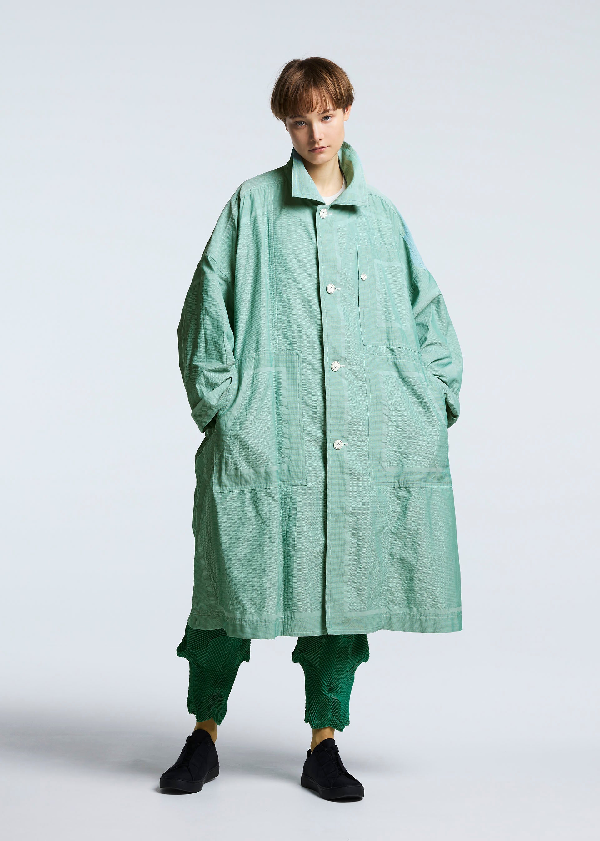 A model wears the A-POC ABLE ISSEY MIYAKE TYPE U 002 coat.