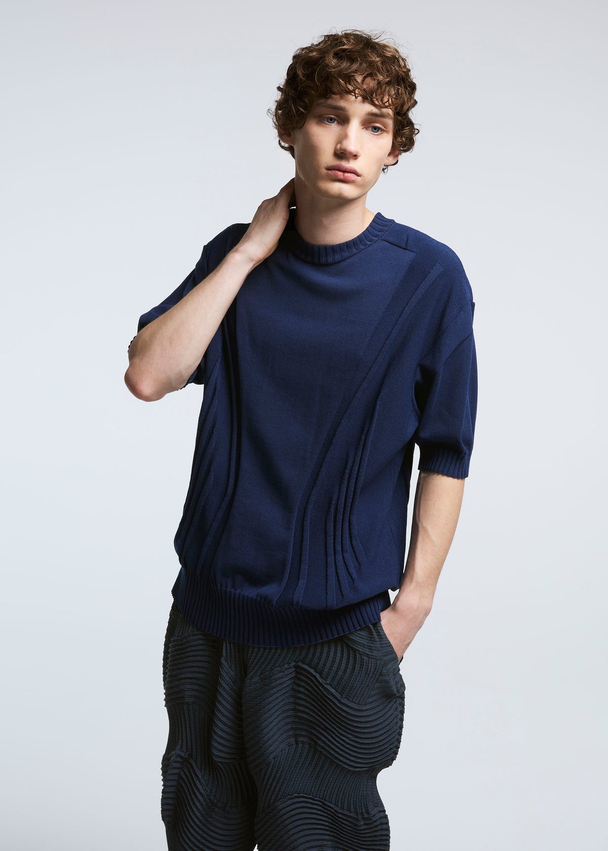 A model wears the A-POC ABLE ISSEY MIYAKE TYPE O 004 trousers.