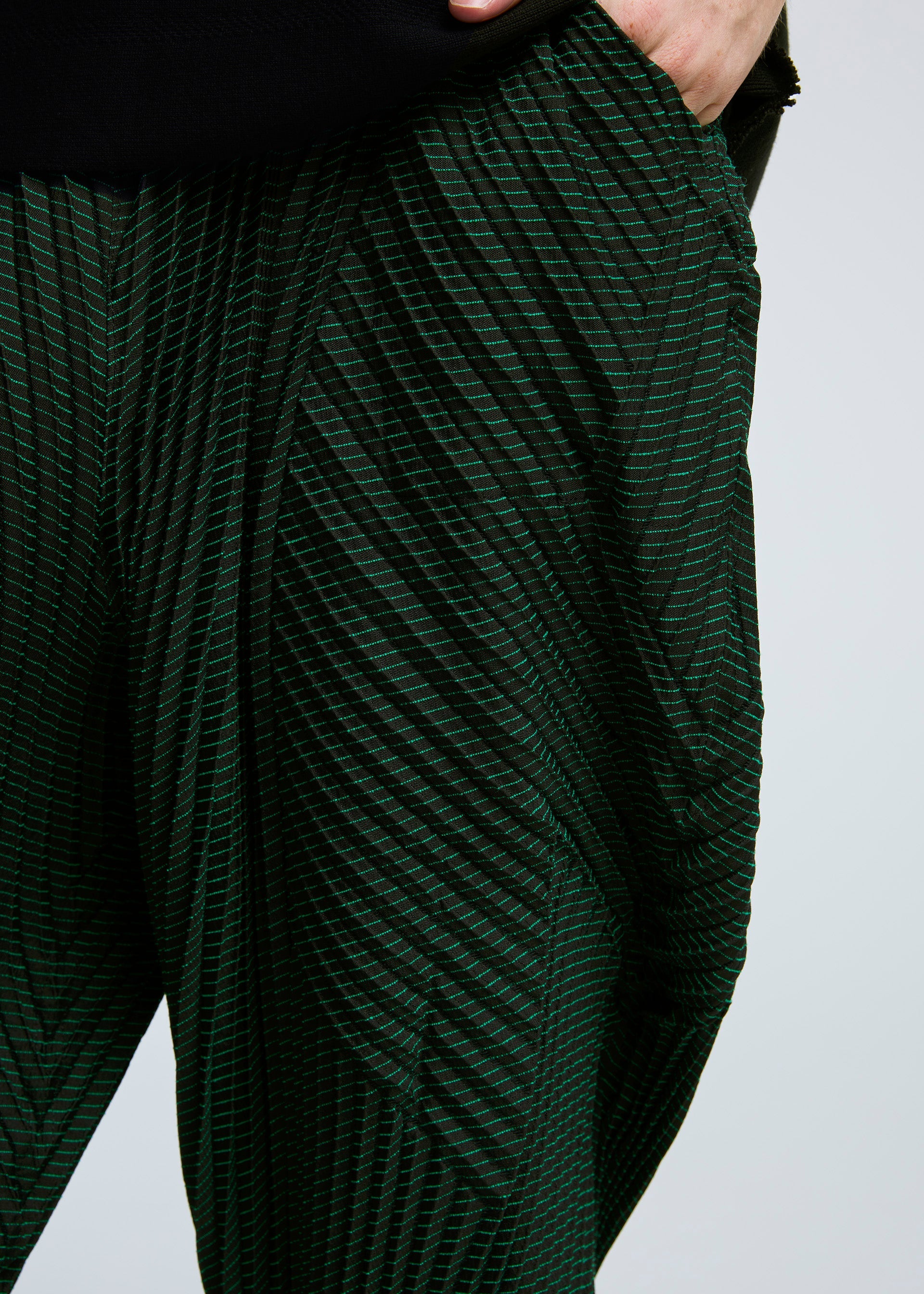 A model wears the A-POC ABLE ISSEY MIYAKE TYPE O 006 trousers.