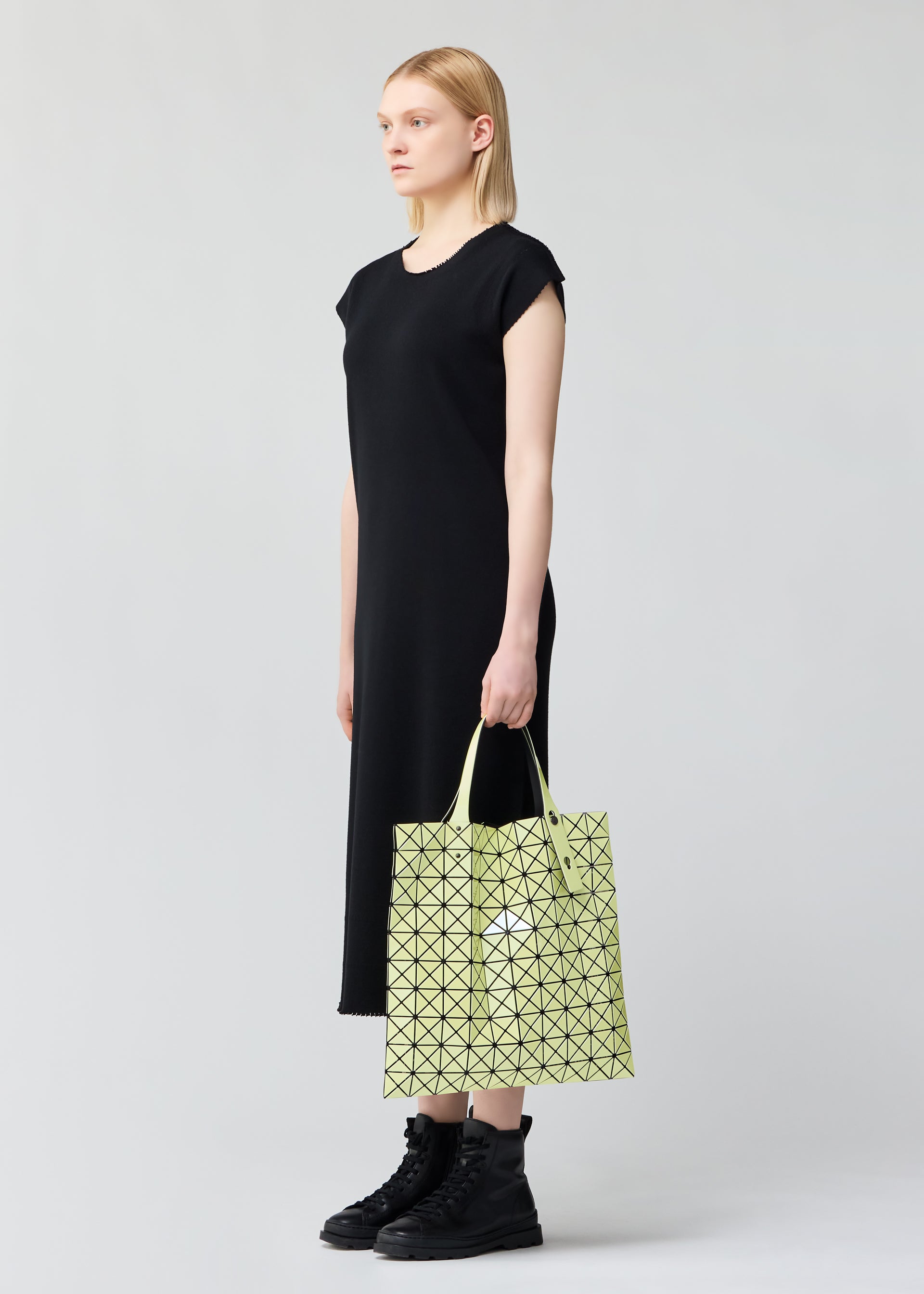 A model wears the BAO BAO ISSEY MIYAKE PRISM METALLIC tote.