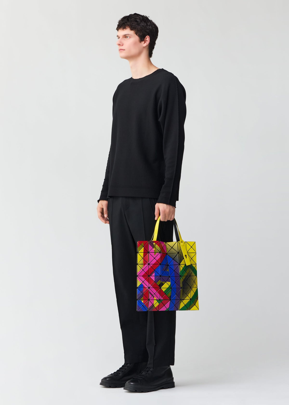 A model wears the BAO BAO ISSEY MIYAKE MANGA tote.