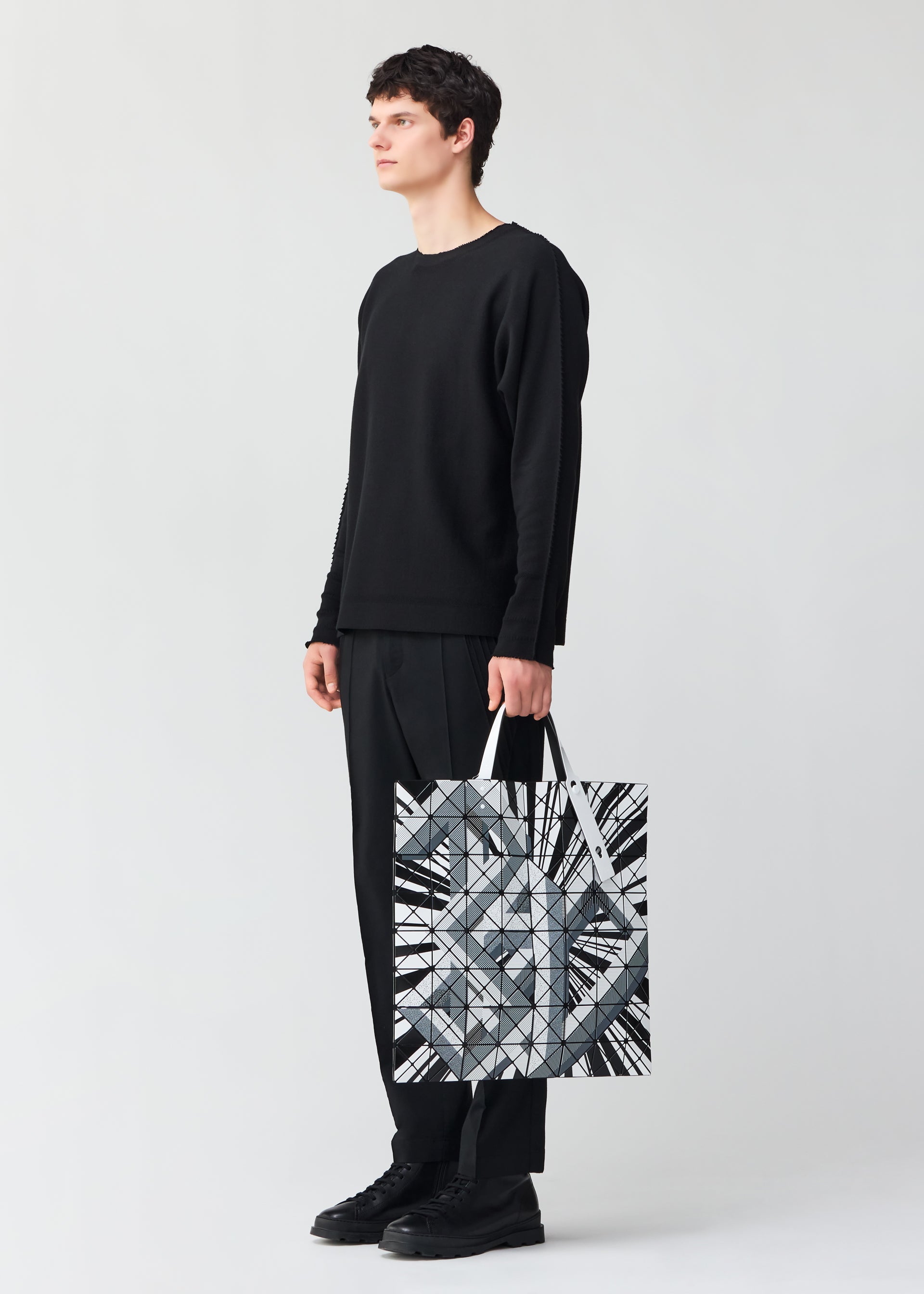 A model wears the BAO BAO ISSEY MIYAKE MANGA tote.