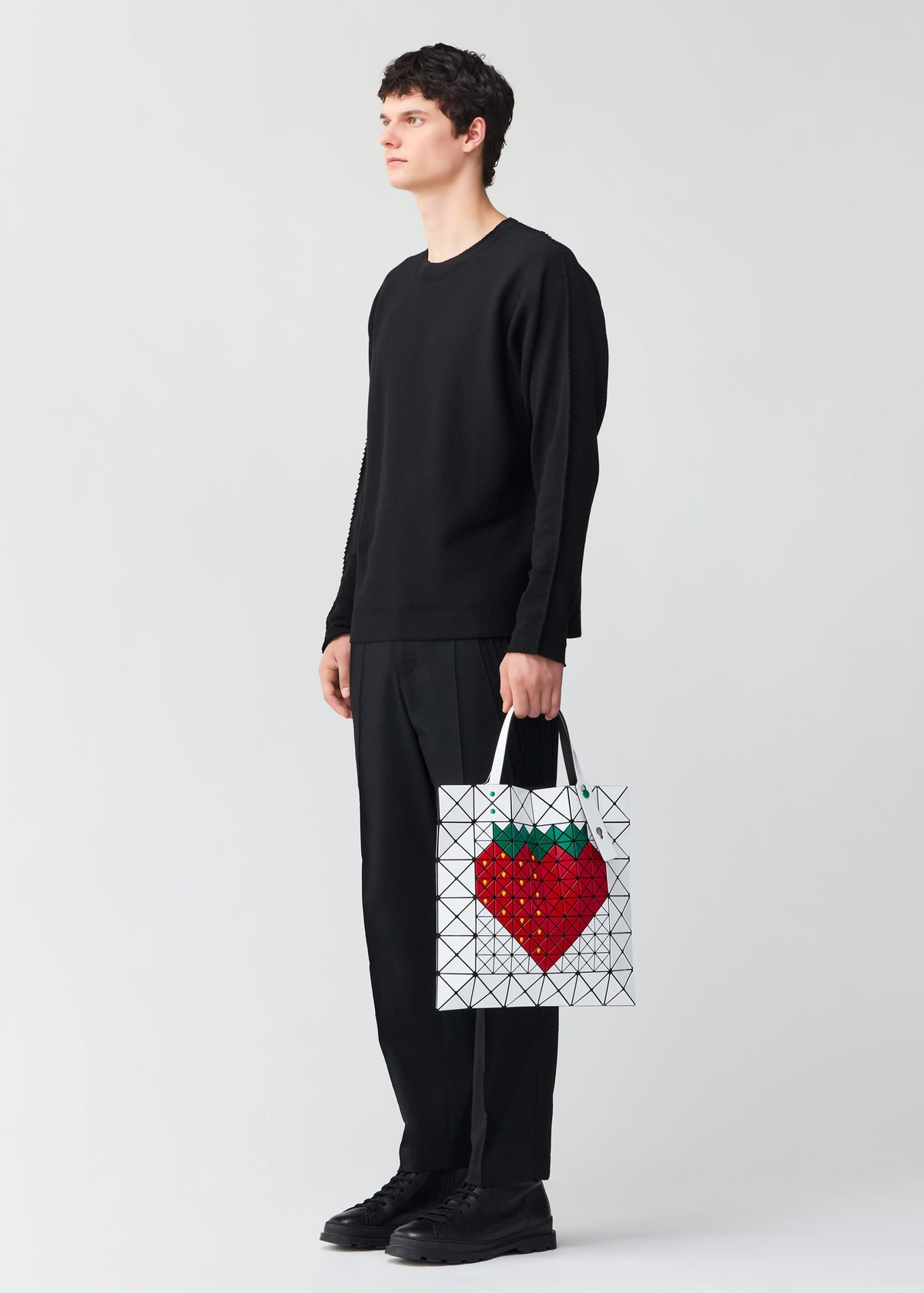 A model wears the BAO BAO ISSEY MIYAKE FRUITS tote.