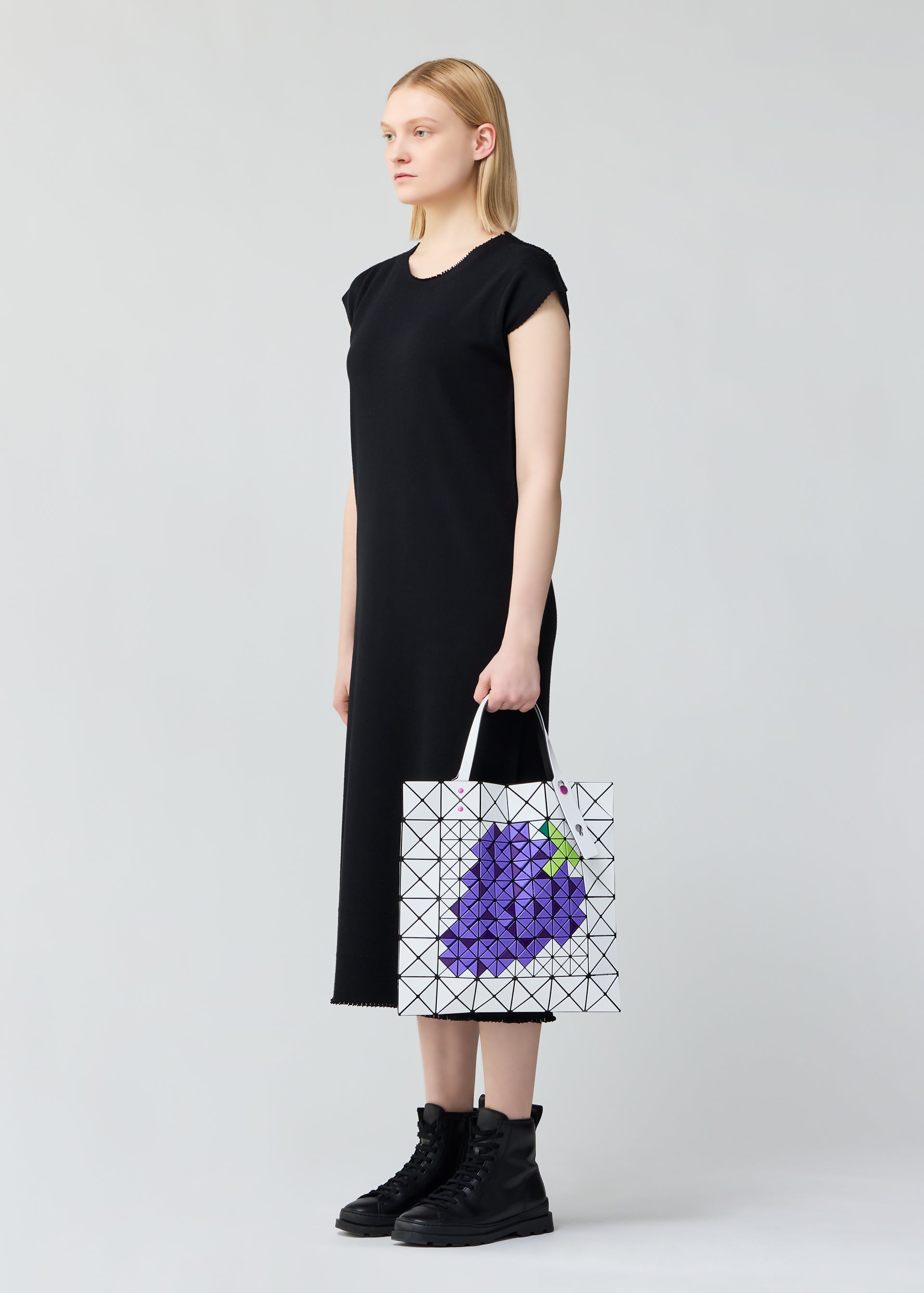 A model wears the BAO BAO ISSEY MIYAKE FRUITS tote.