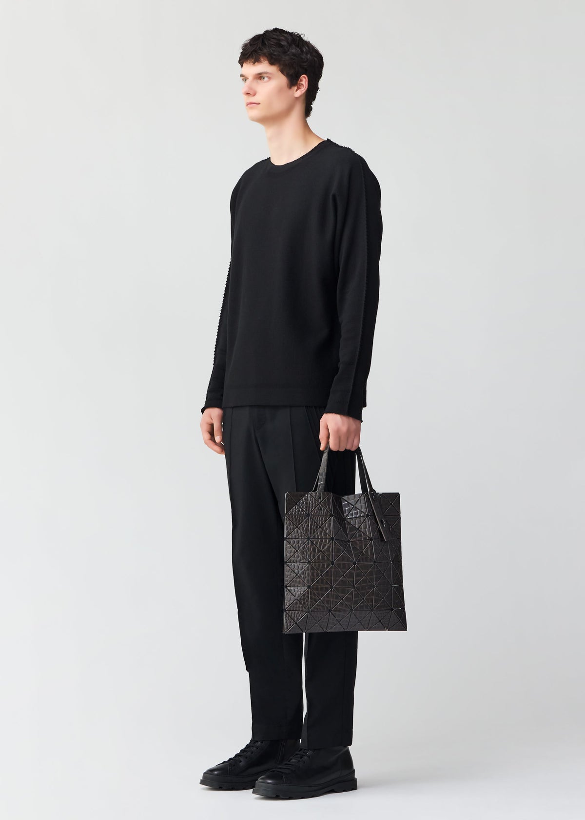 A model wears the BAO BAO ISSEY MIYAKE KAIJU tote.