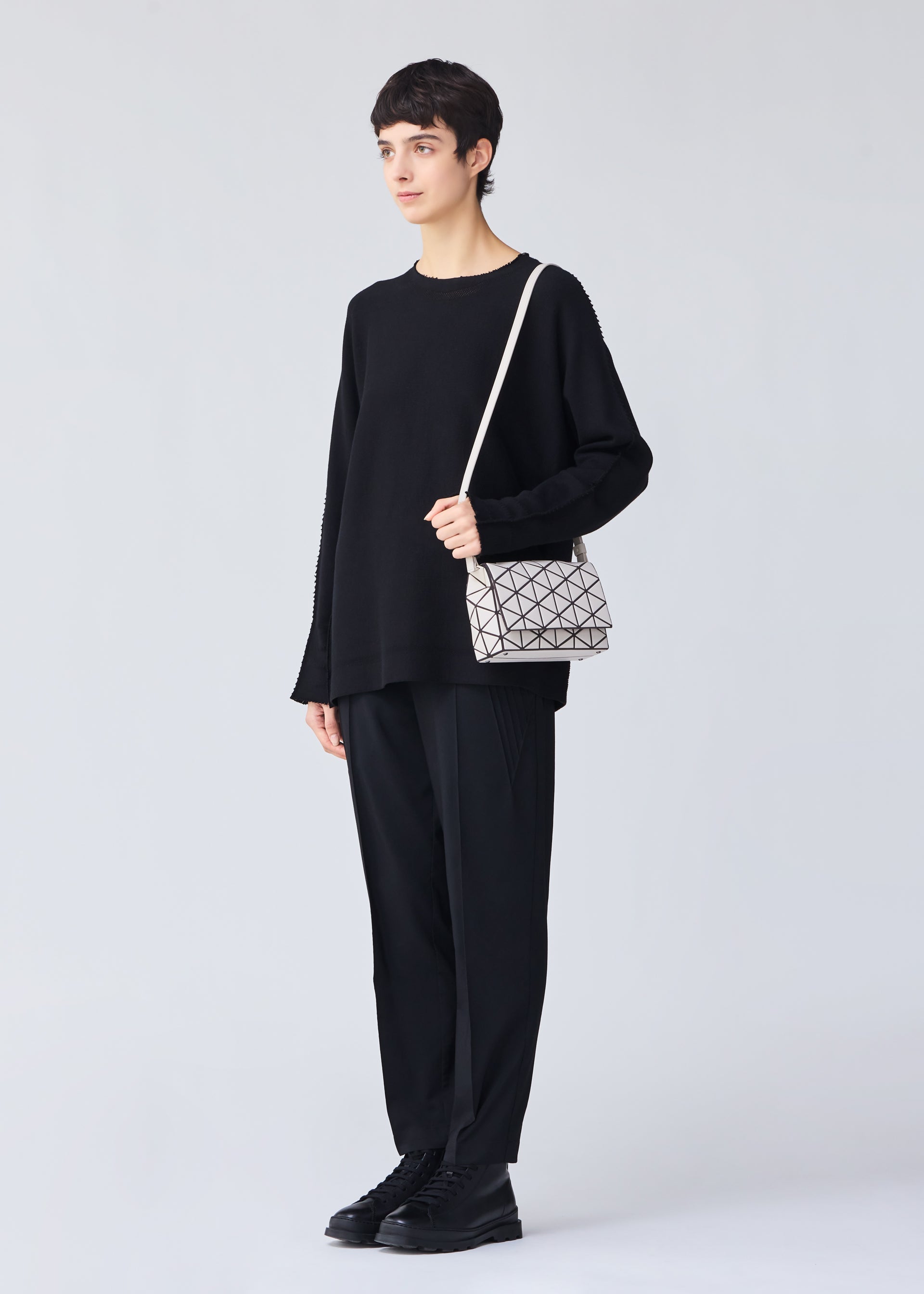 A model wears the BAO BAO ISSEY MIYAKE FOSSETTE shoulder bag.