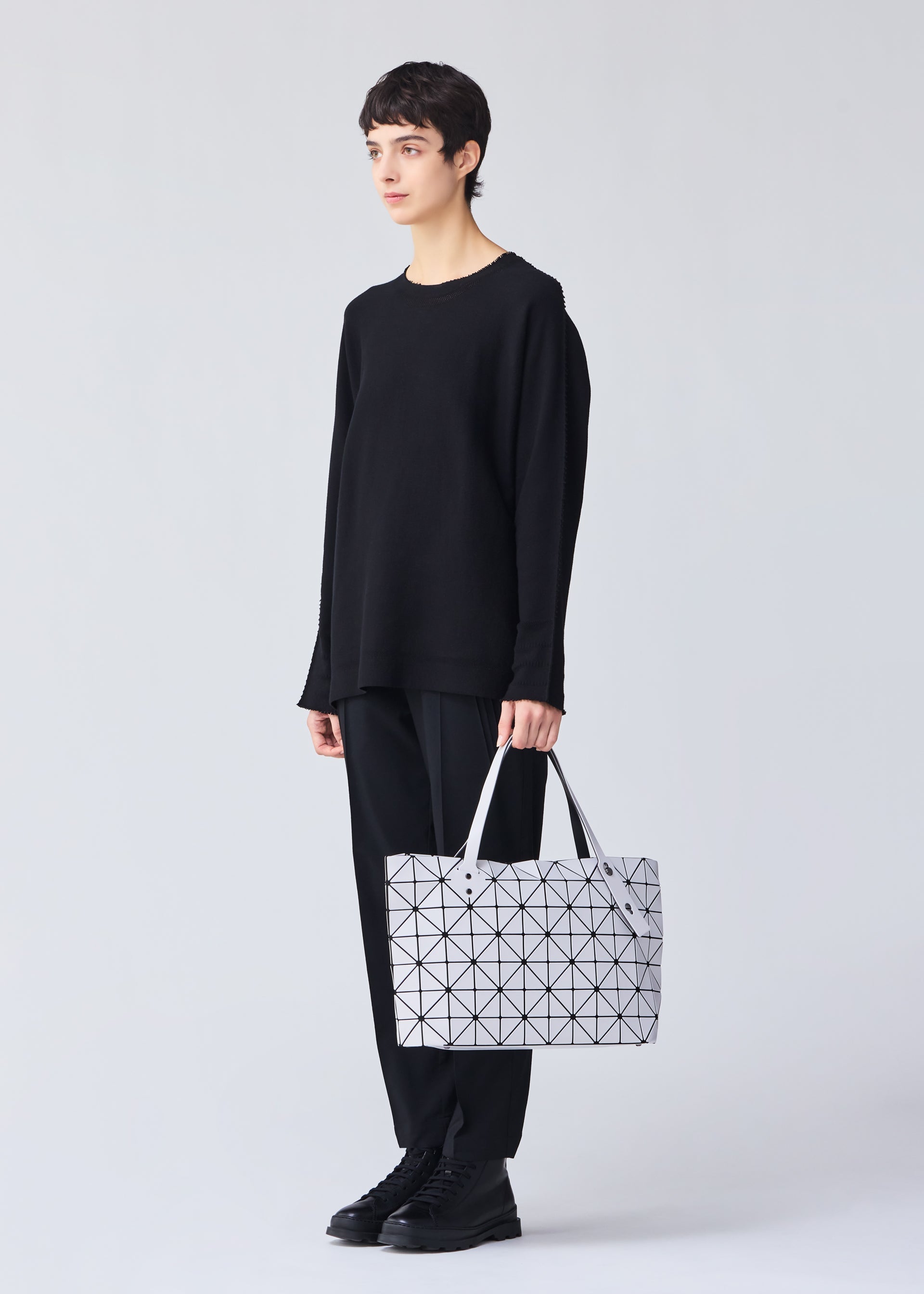 A model wears the BAO BAO ISSEY MIYAKE ROCK MATTE 0.