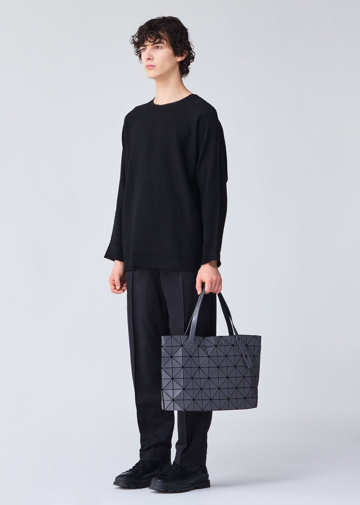 A model wears the BAO BAO ISSEY MIYAKE ROCK MATTE 0.