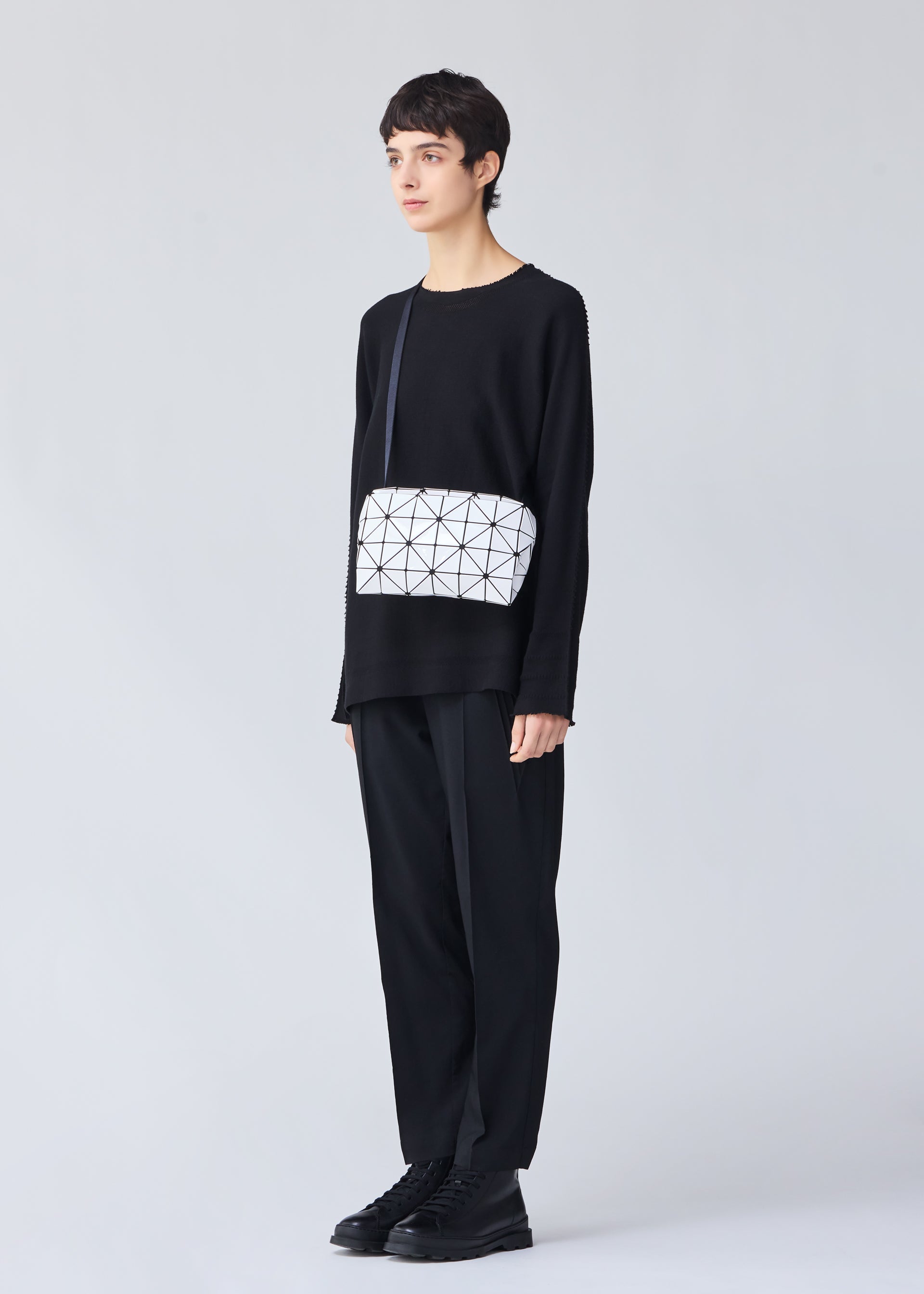 A model wears the BAO BAO ISSEY MIYAKE CARTON shoulder bag.