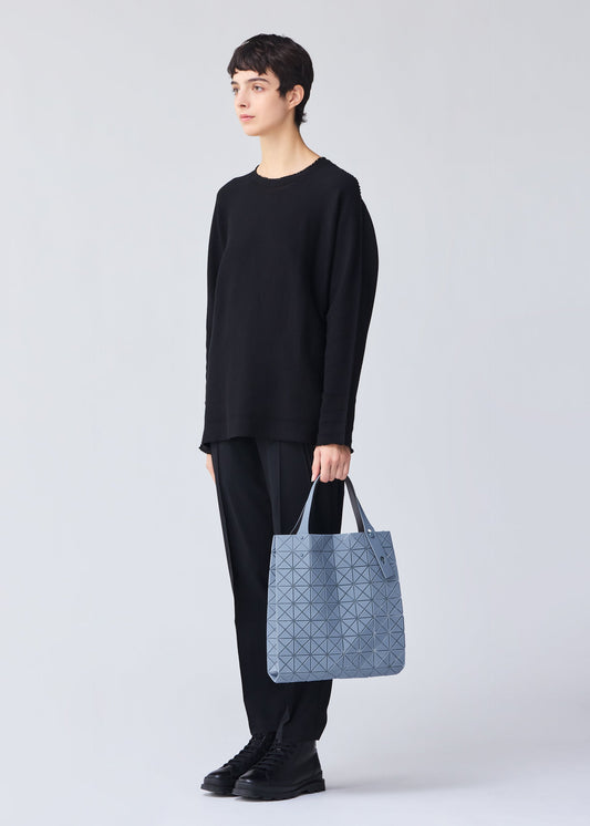 A model wears the BAO BAO ISSEY MIYAKE PRISM PLUS tote.
