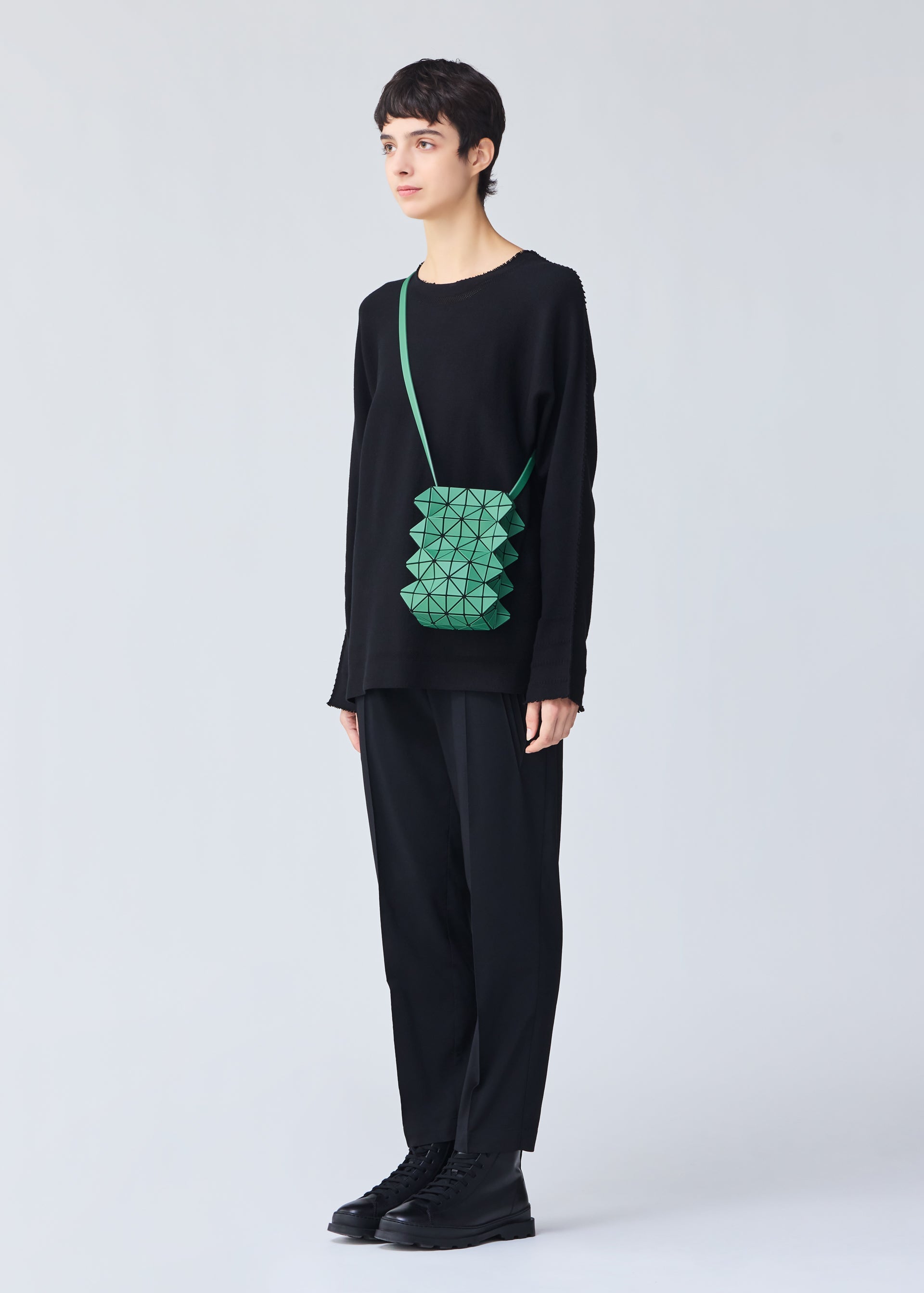 A model wears the BAO BAO ISSEY MIYAKE GROWTH shoulder bag.