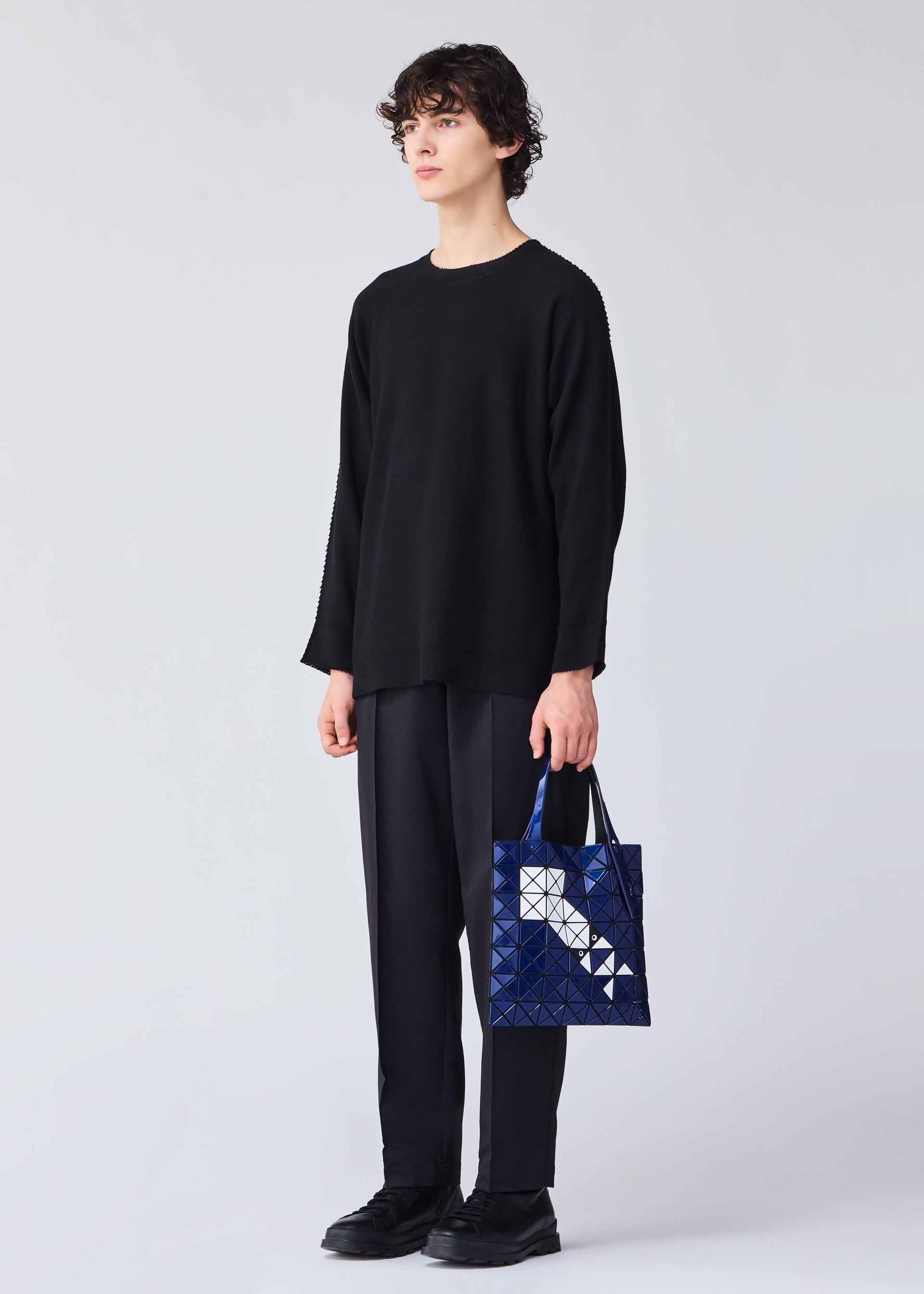 A model wears the BAO BAO ISSEY MIYAKE WONDER tote.