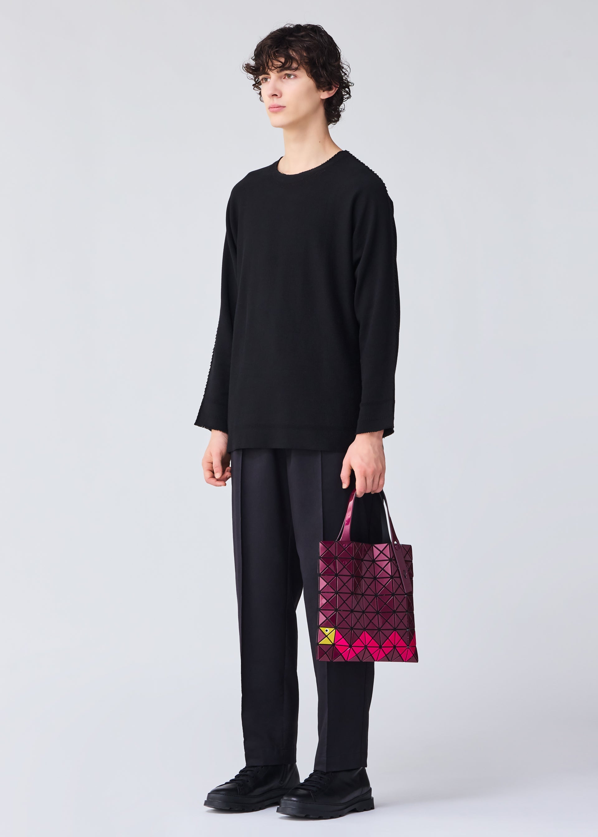 A model wears the BAO BAO ISSEY MIYAKE WONDER tote.