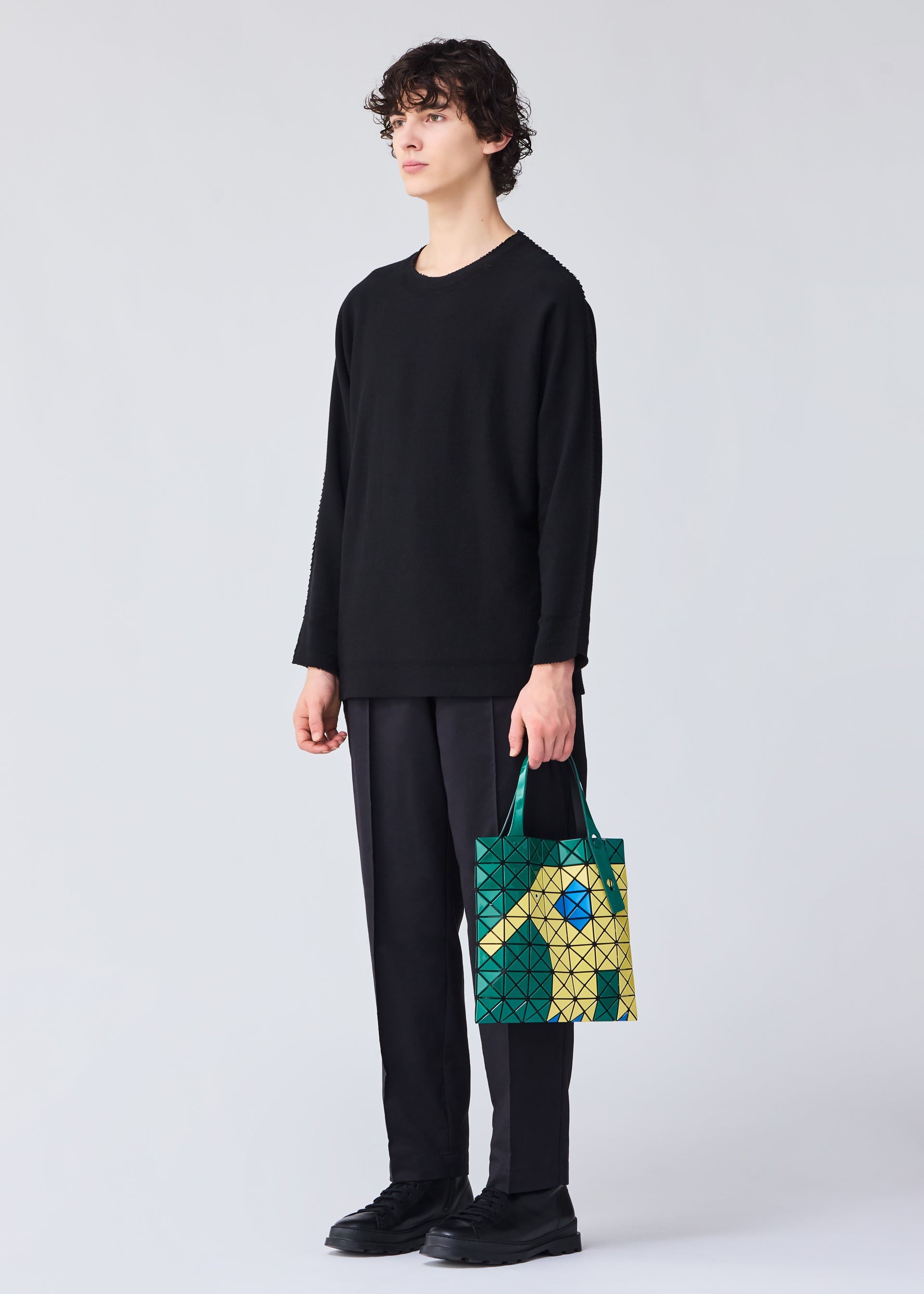 A model wears the BAO BAO ISSEY MIYAKE WONDER tote.