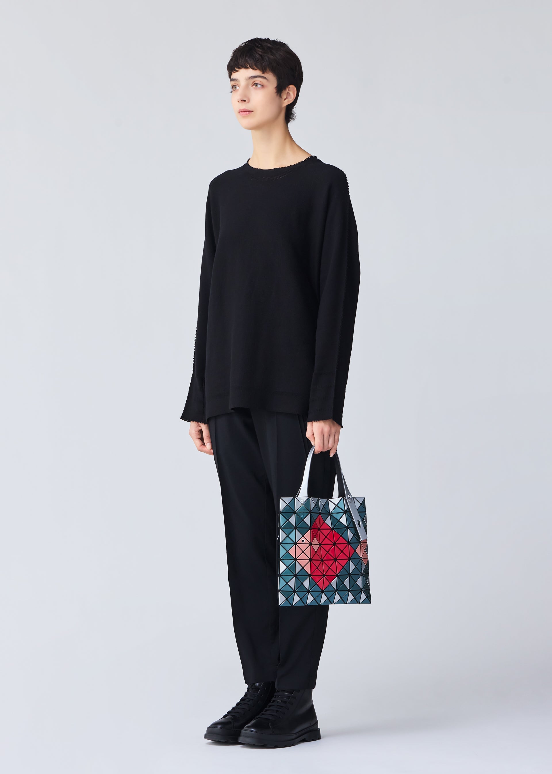 A model wears the BAO BAO ISSEY MIYAKE WONDER tote.