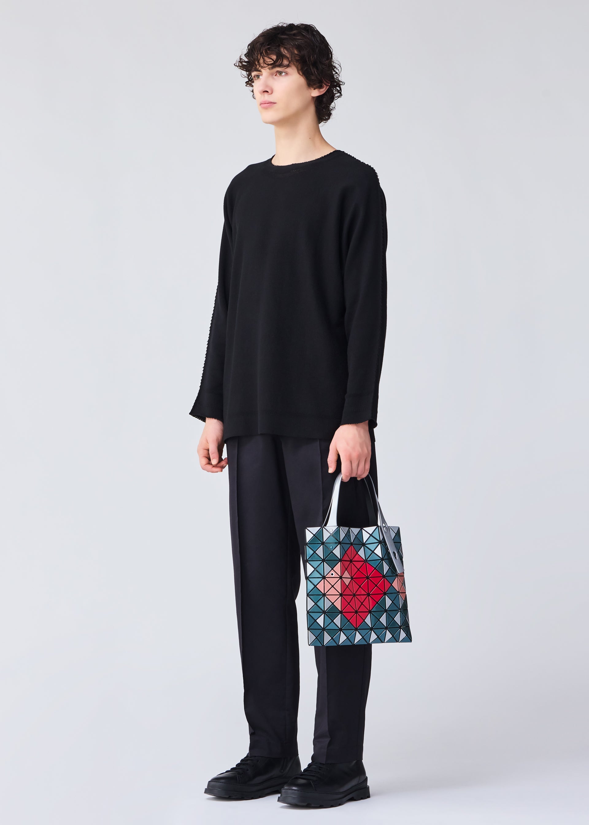 A model wears the BAO BAO ISSEY MIYAKE WONDER tote.