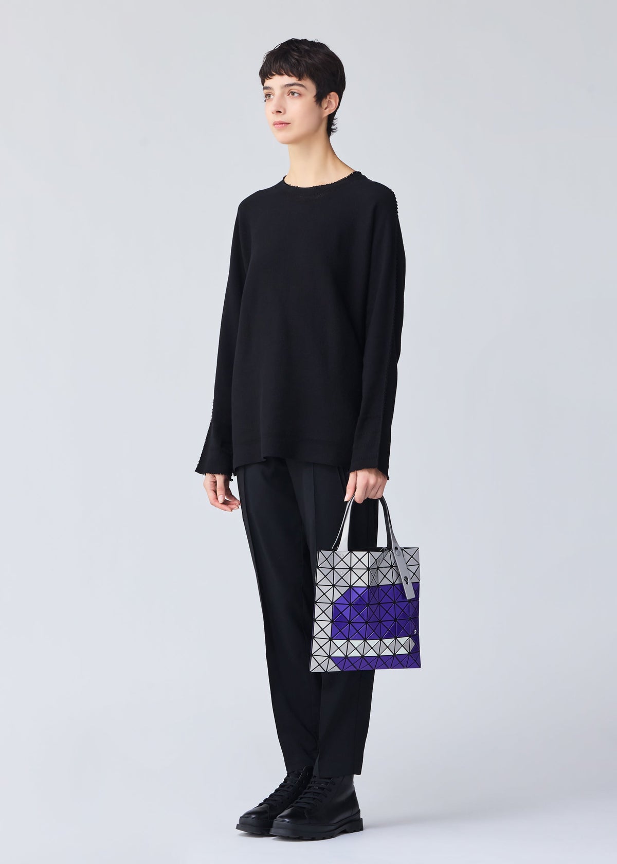 A model wears the BAO BAO ISSEY MIYAKE WONDER tote.