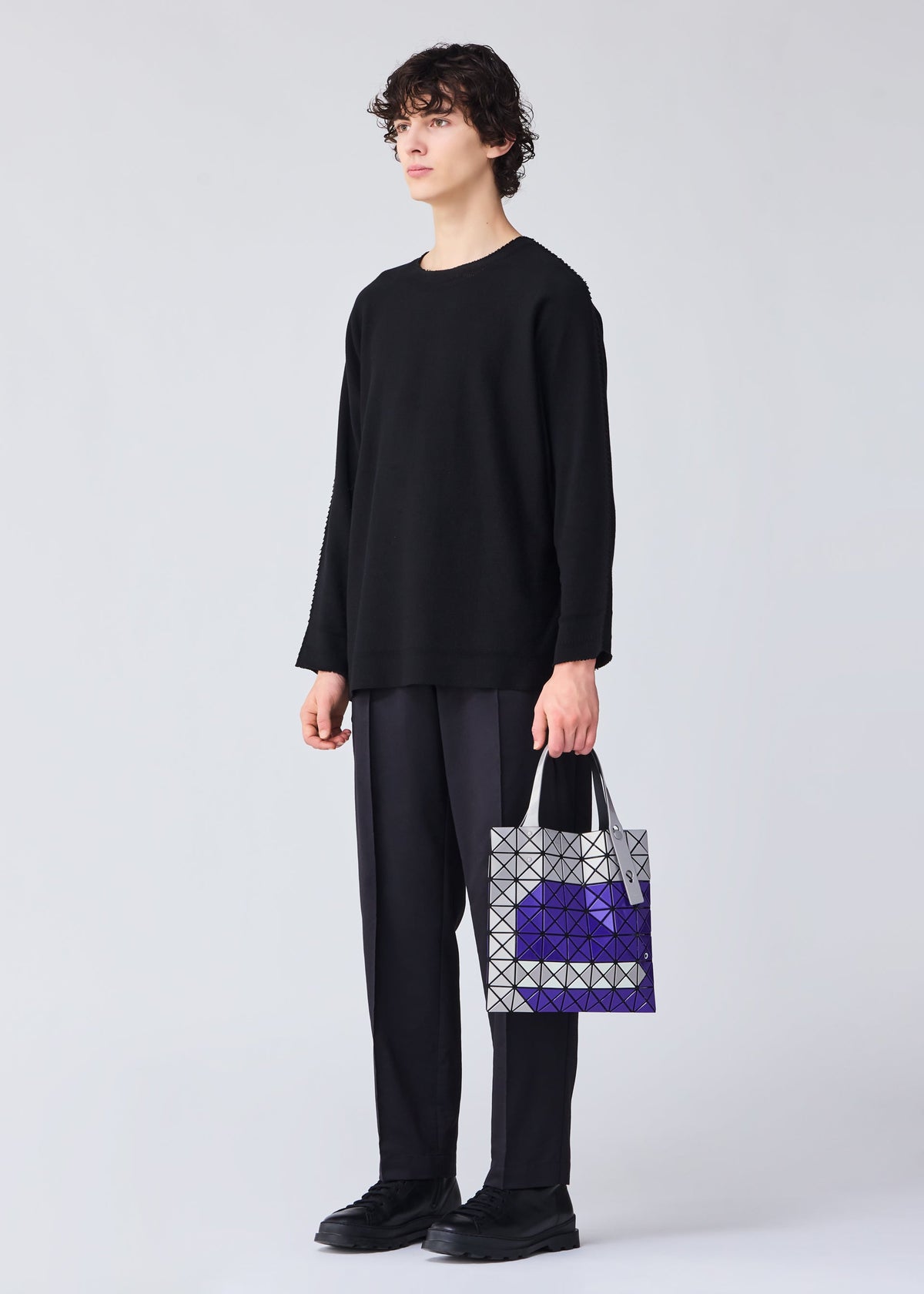 A model wears the BAO BAO ISSEY MIYAKE WONDER tote.