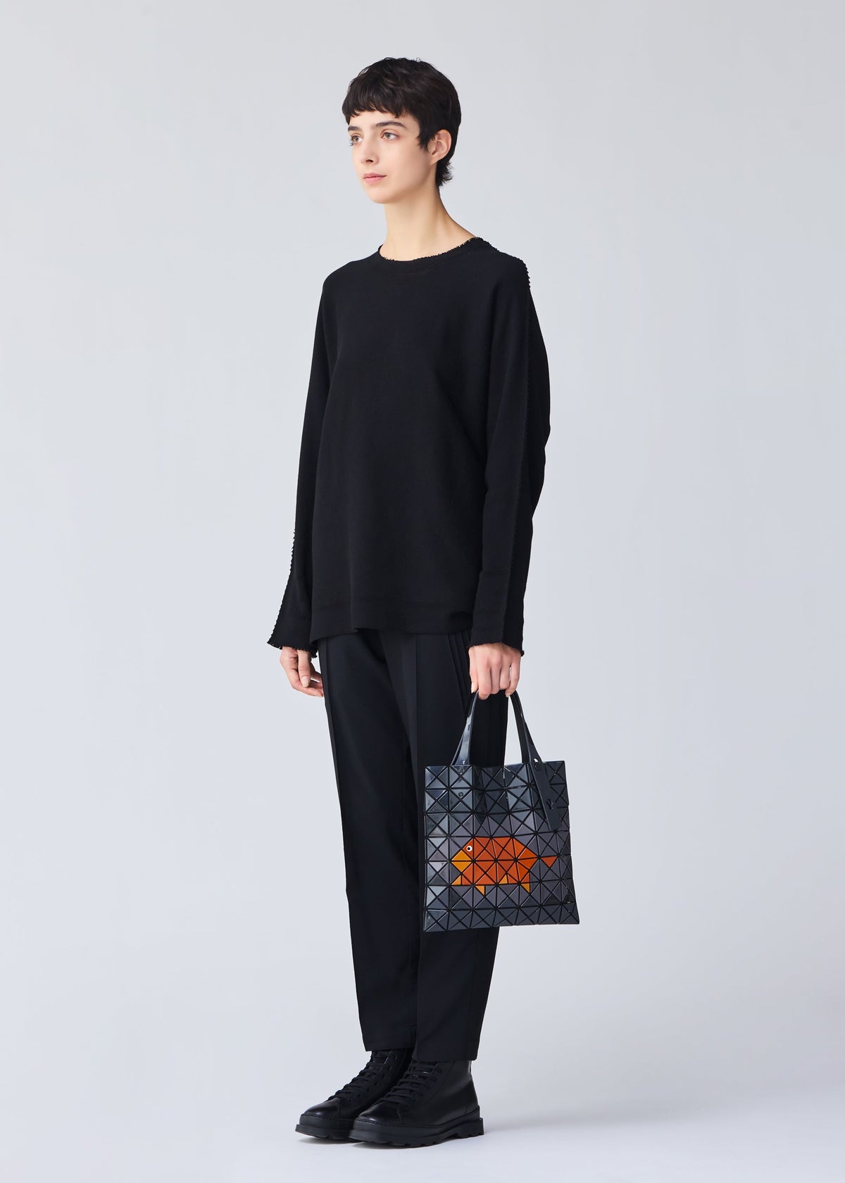 A model wears the BAO BAO ISSEY MIYAKE WONDER tote.