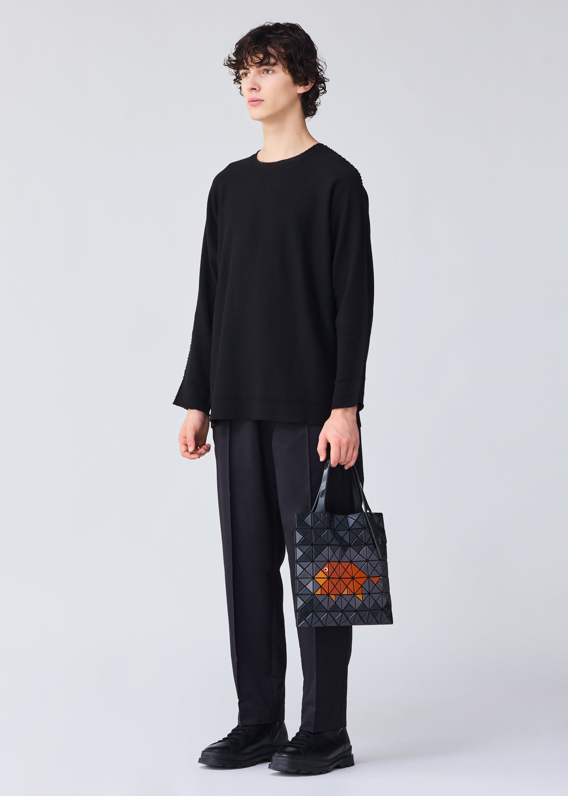 A model wears the BAO BAO ISSEY MIYAKE WONDER tote.