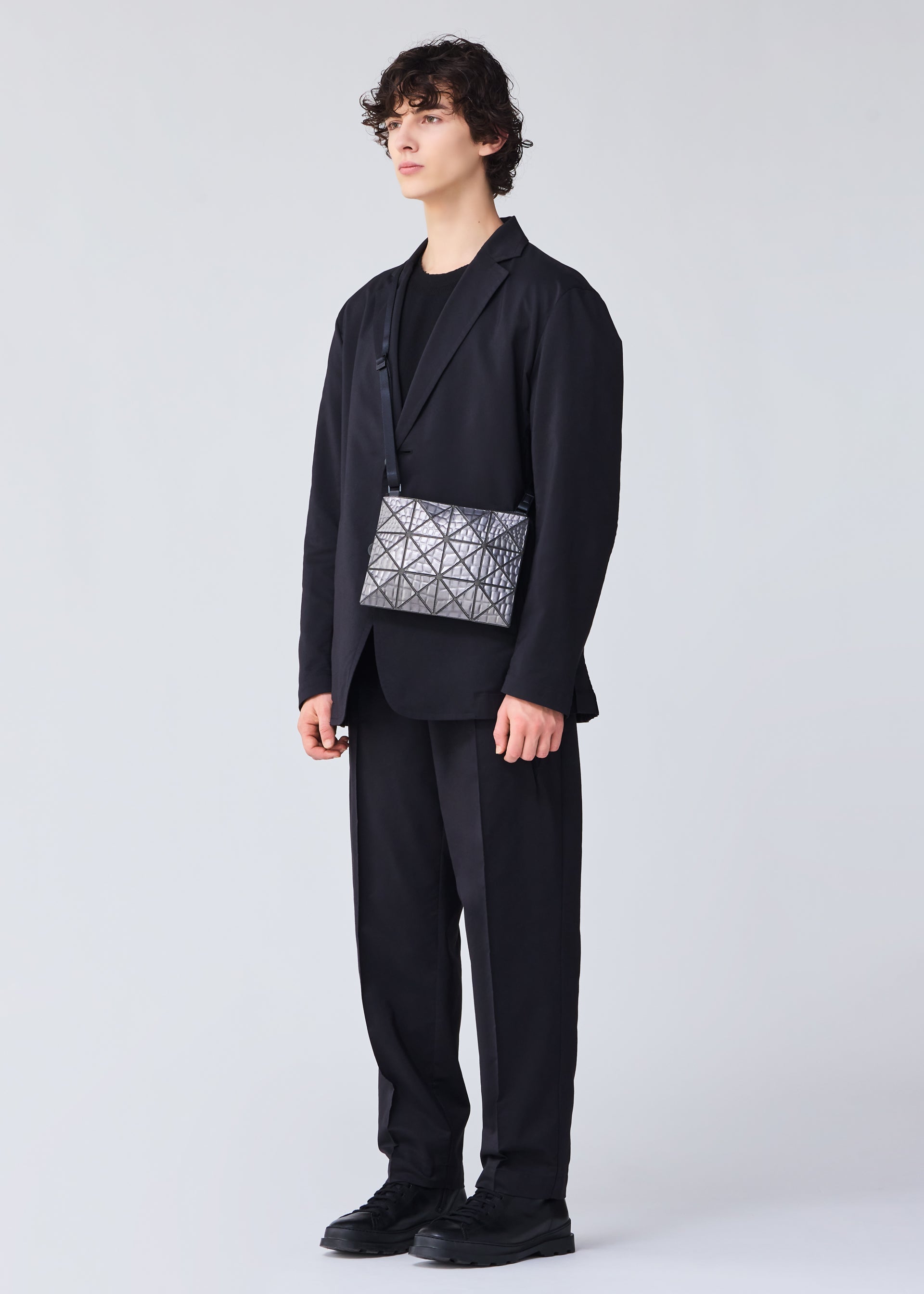 A model wears the BAO BAO ISSEY MIYAKE META KAIJU crossbody.