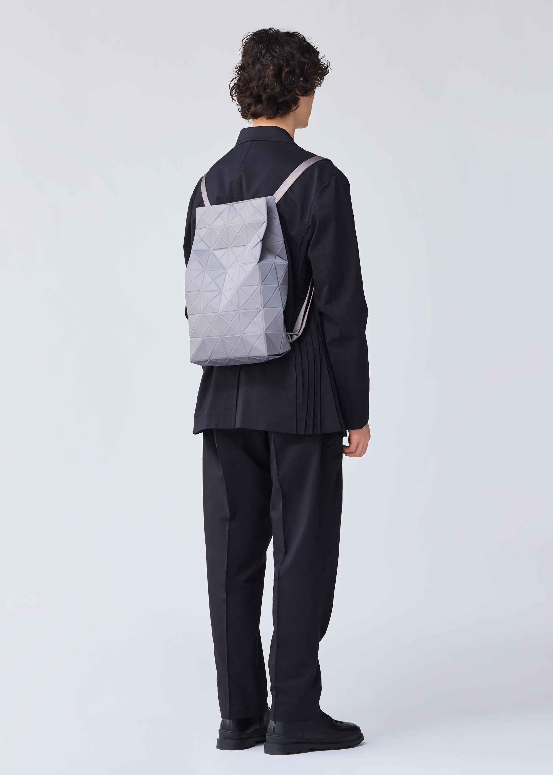 A model wears the BAO BAO ISSEY MIYAKE TRACK backpack.