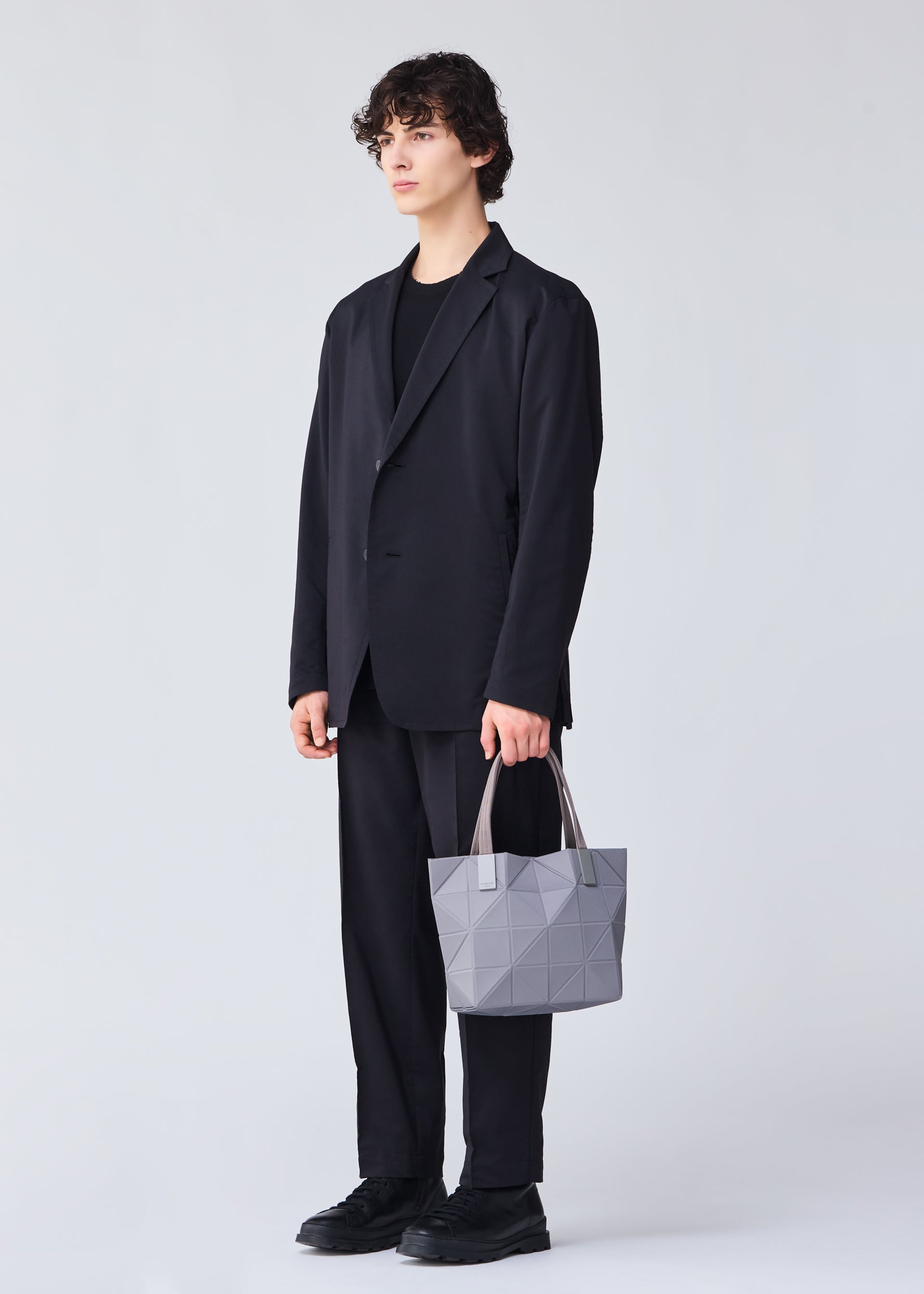 A model wears the BAO BAO ISSEY MIYAKE TRACK 0.