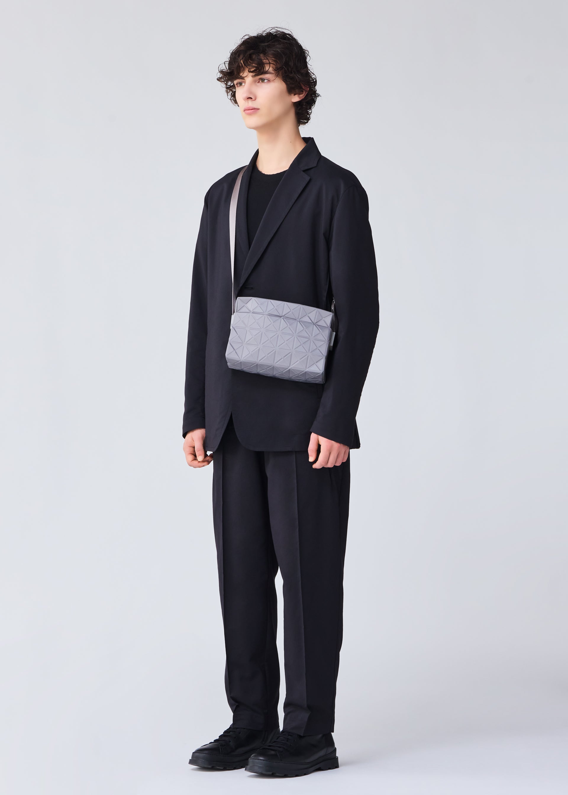 A model wears the BAO BAO ISSEY MIYAKE TRACK shoulder bag.