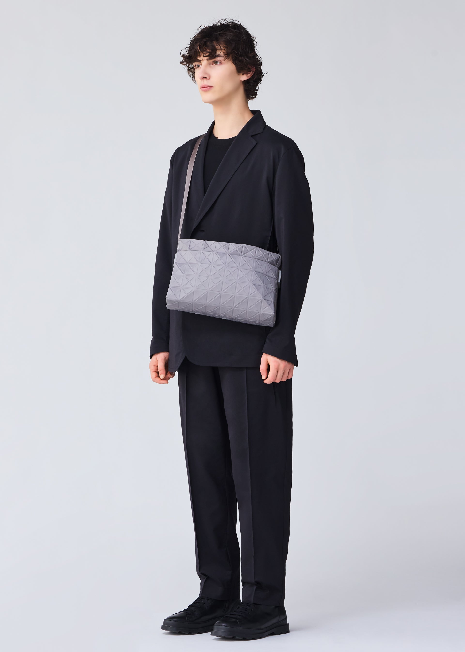 A model wears the BAO BAO ISSEY MIYAKE TRACK shoulder bag.