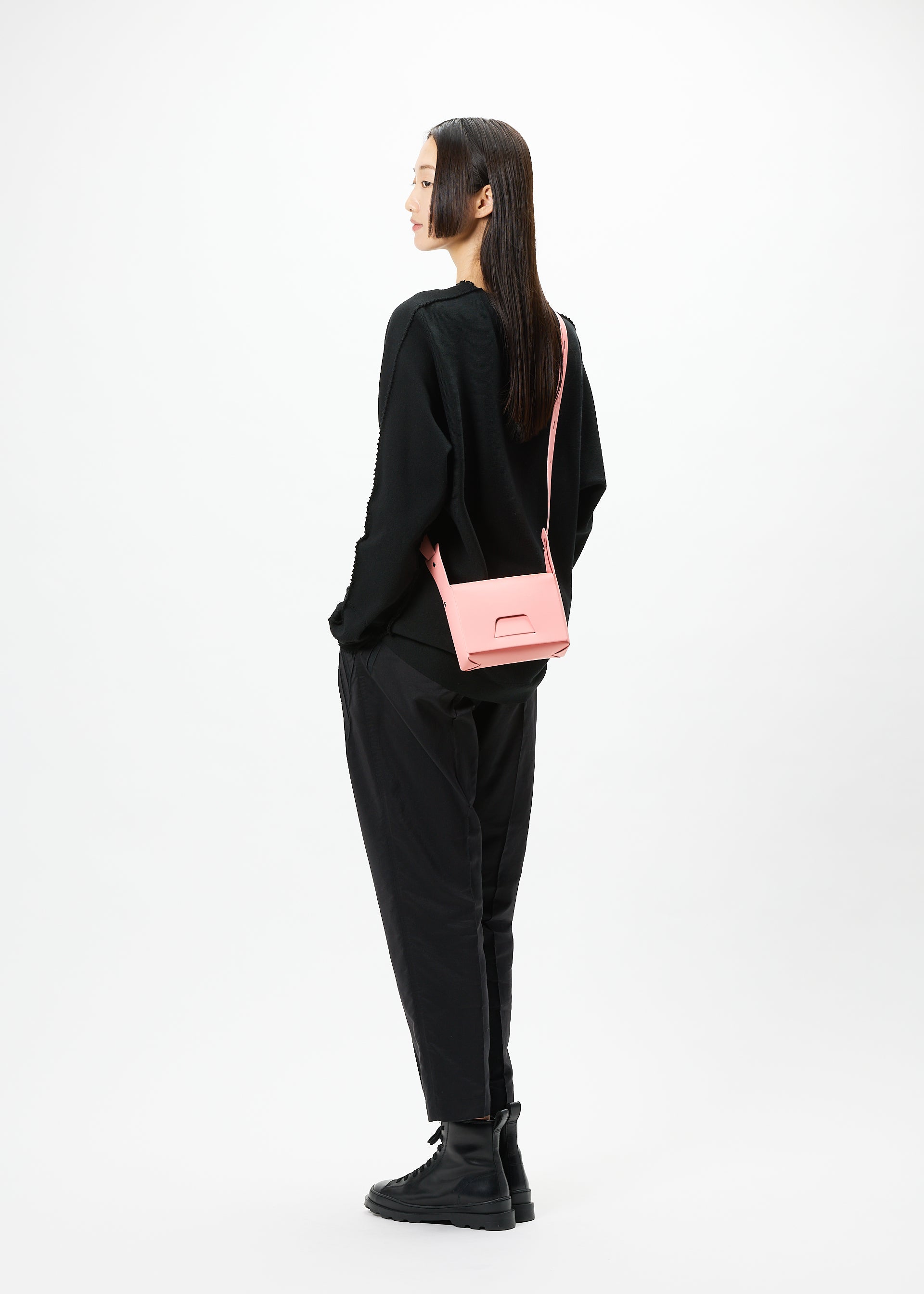 A model wears the GOOD GOODS ISSEY MIYAKE BOX bag.