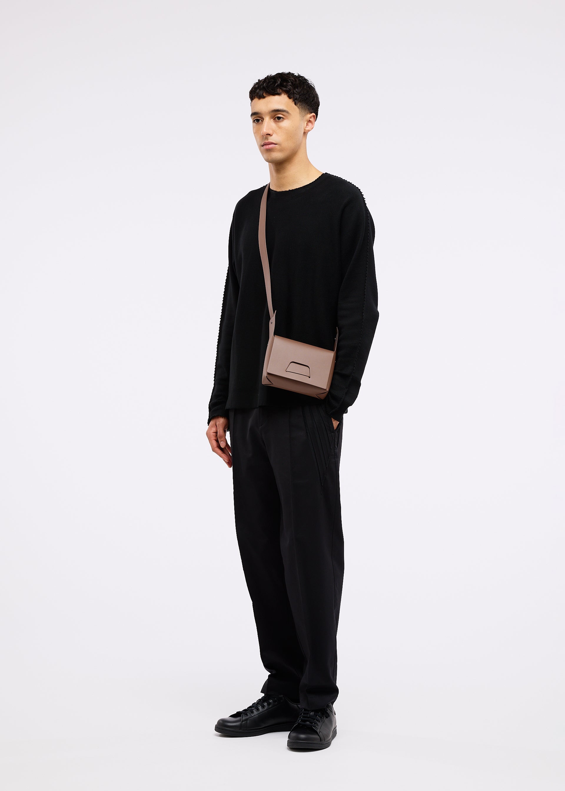 A model wears the GOOD GOODS ISSEY MIYAKE BOX bag.