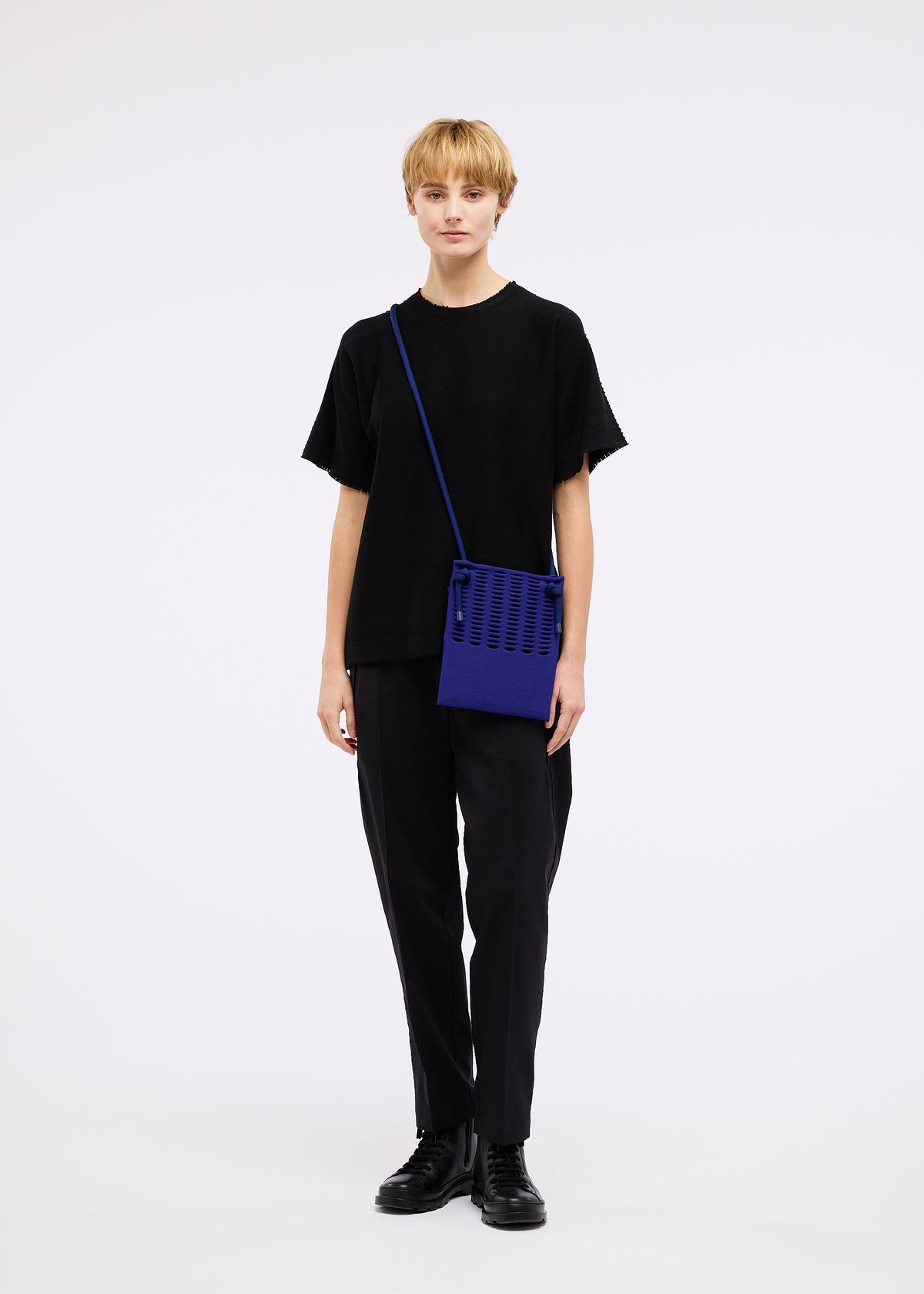 A model wears the GOOD GOODS ISSEY MIYAKE MOKKO KNAPSACK bag.