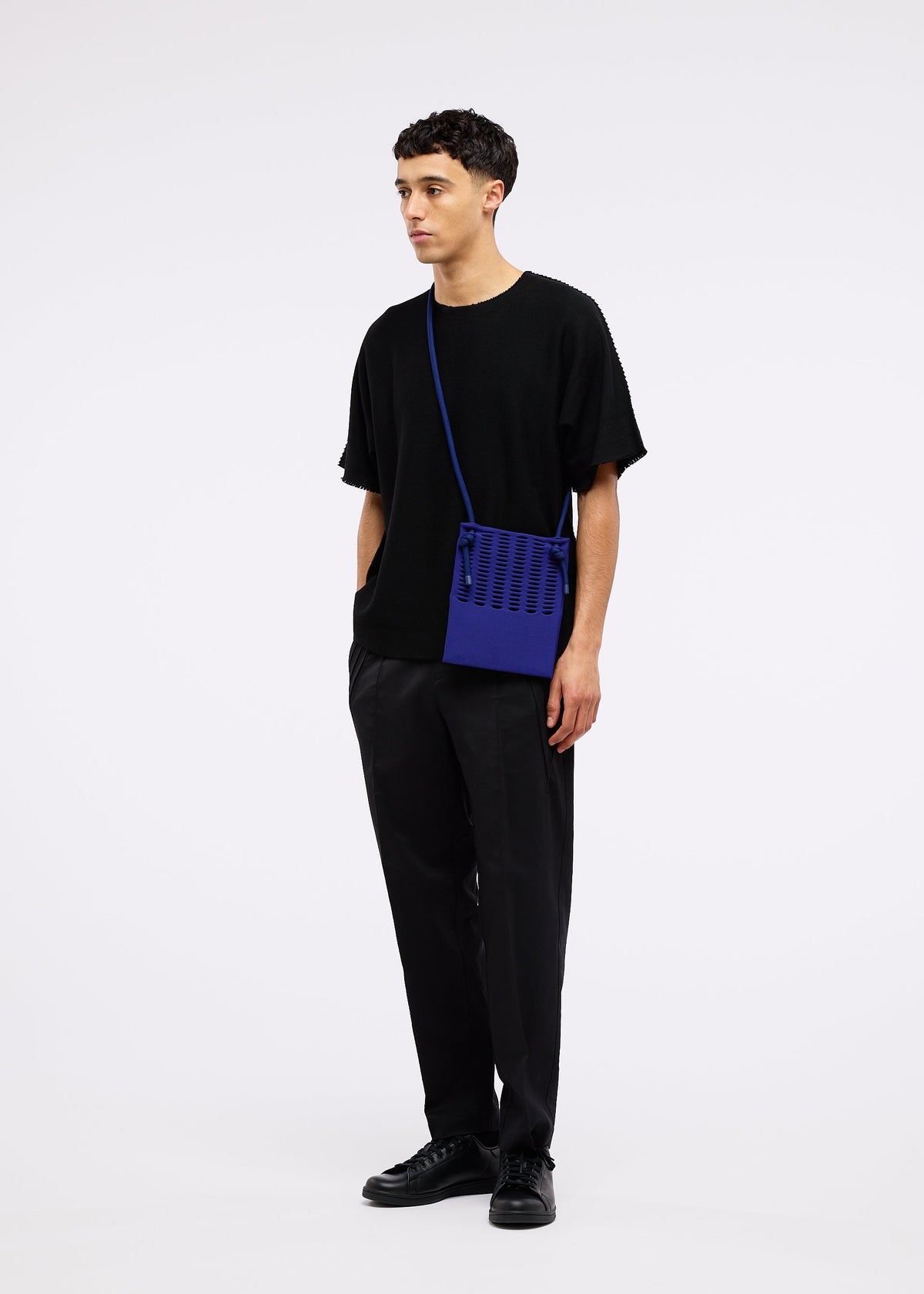 A model wears the GOOD GOODS ISSEY MIYAKE MOKKO KNAPSACK bag.