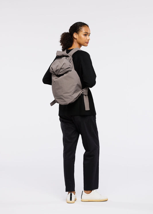 A model wears the GOOD GOODS ISSEY MIYAKE FUWA FUWA bags.