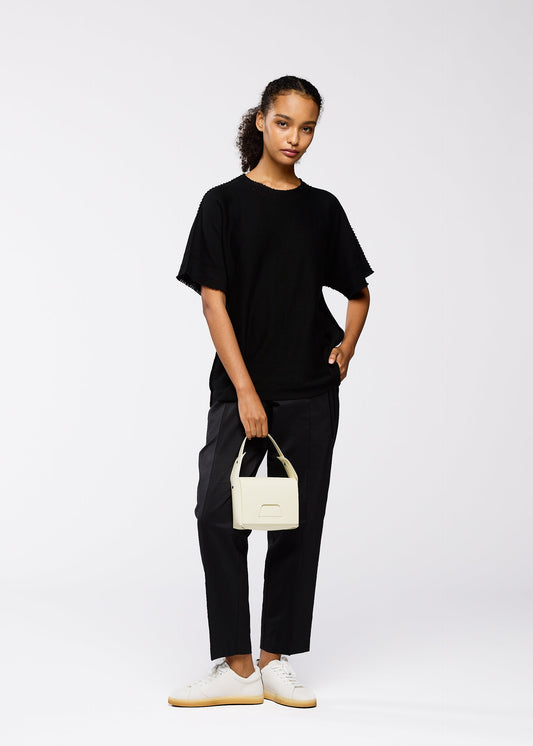 A model wears the GOOD GOODS ISSEY MIYAKE BOX bag.