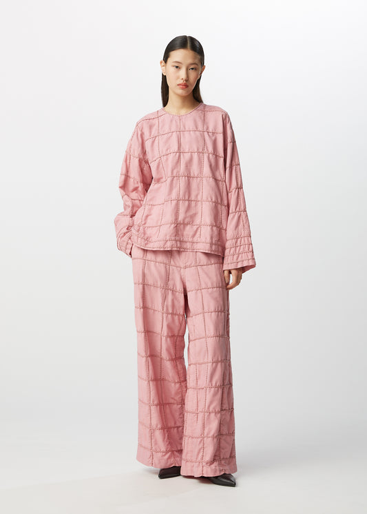 A model wears the HAAT GLIMMERED DOT trousers