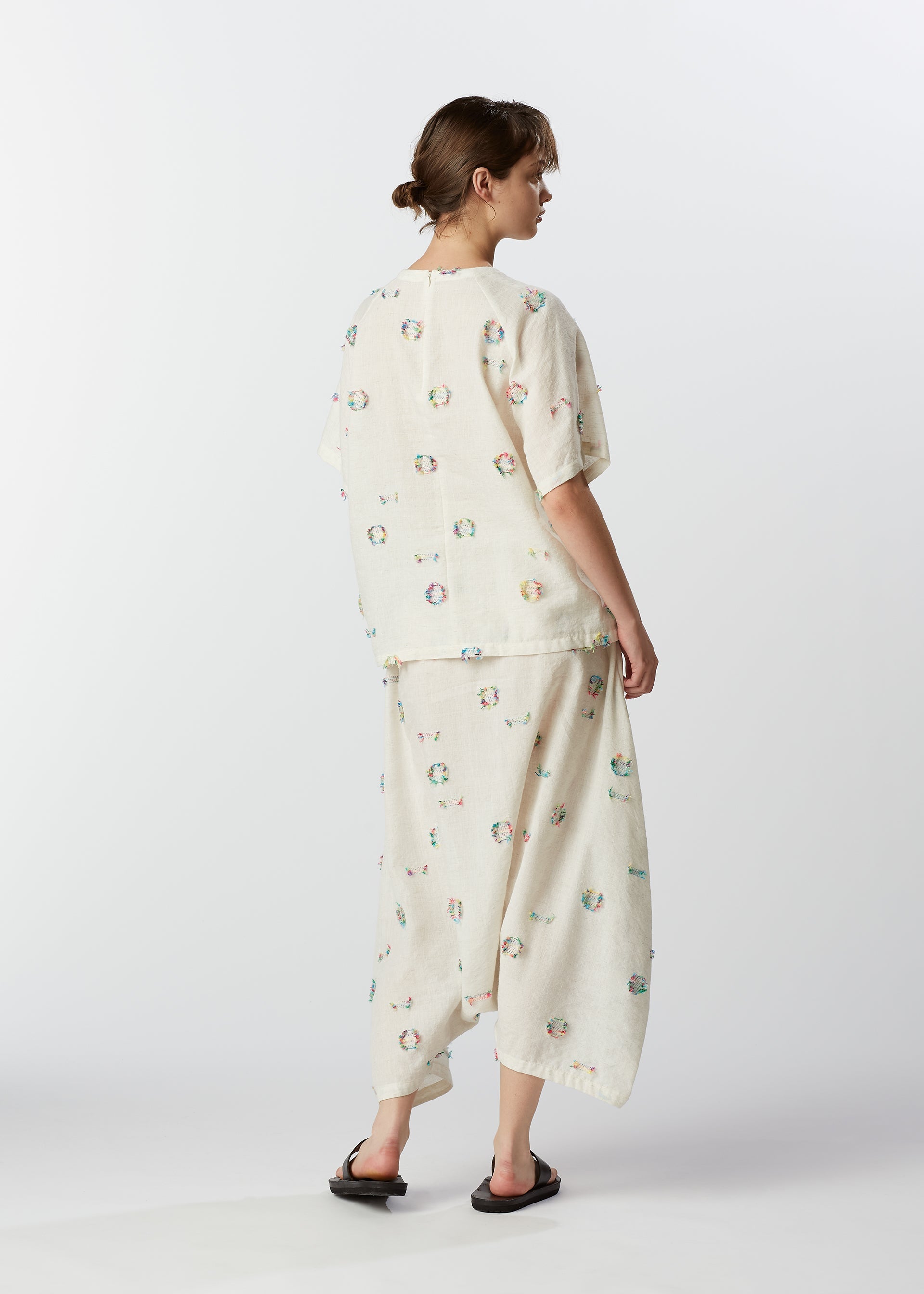 A model wears the HAAT KOMOREBI trousers.