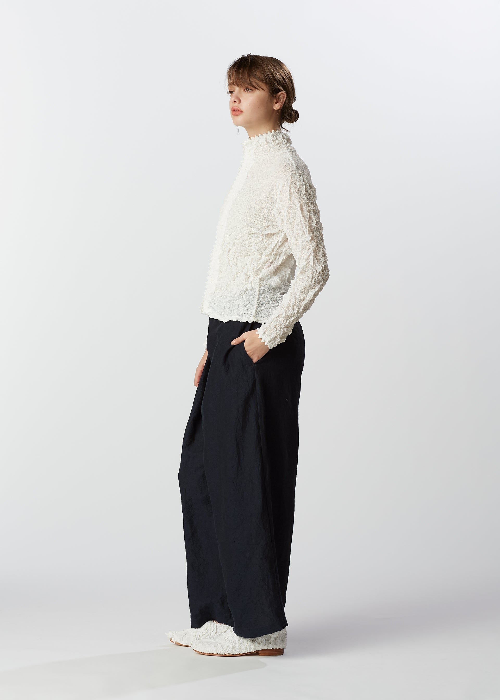 A model wears the HAAT KUMO SHIBORI SUCKER shirt.