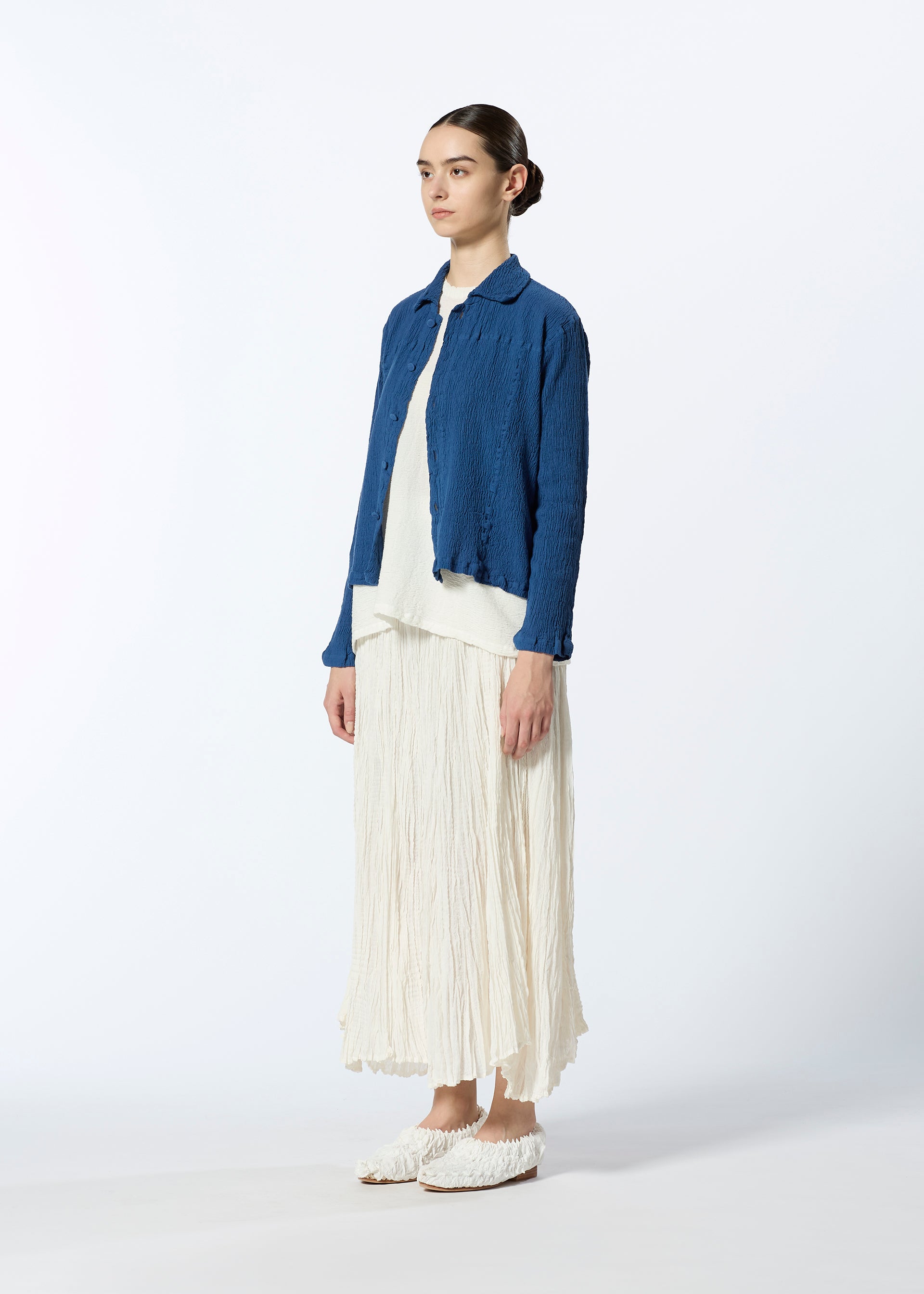 A model wears the HAAT TATSUMAKI SKIRT skirt.