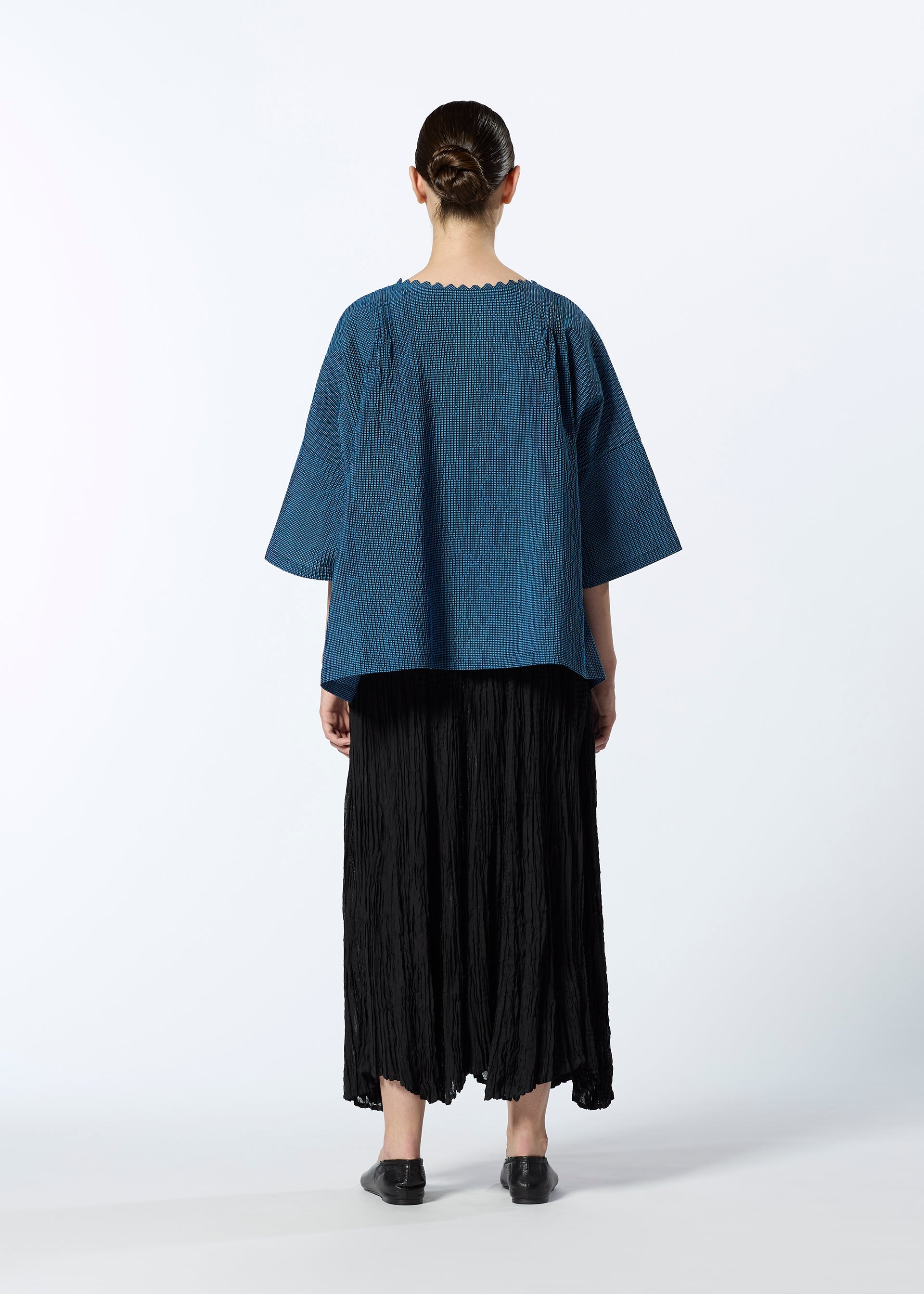 A model wears the HAAT TATSUMAKI SKIRT skirt.