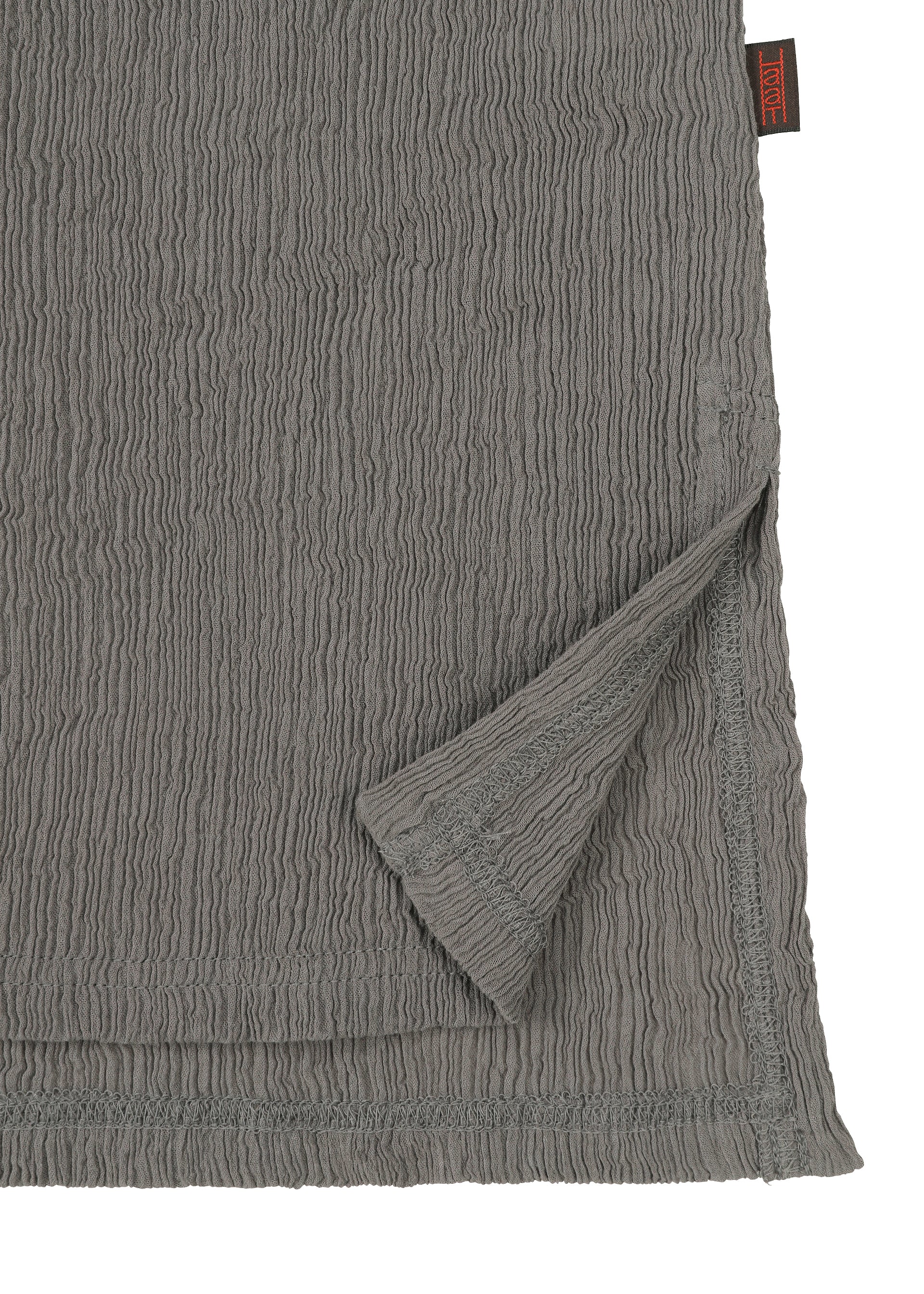A detail shot of the HAAT KYO CHIJIMI COMBINATION shirt.